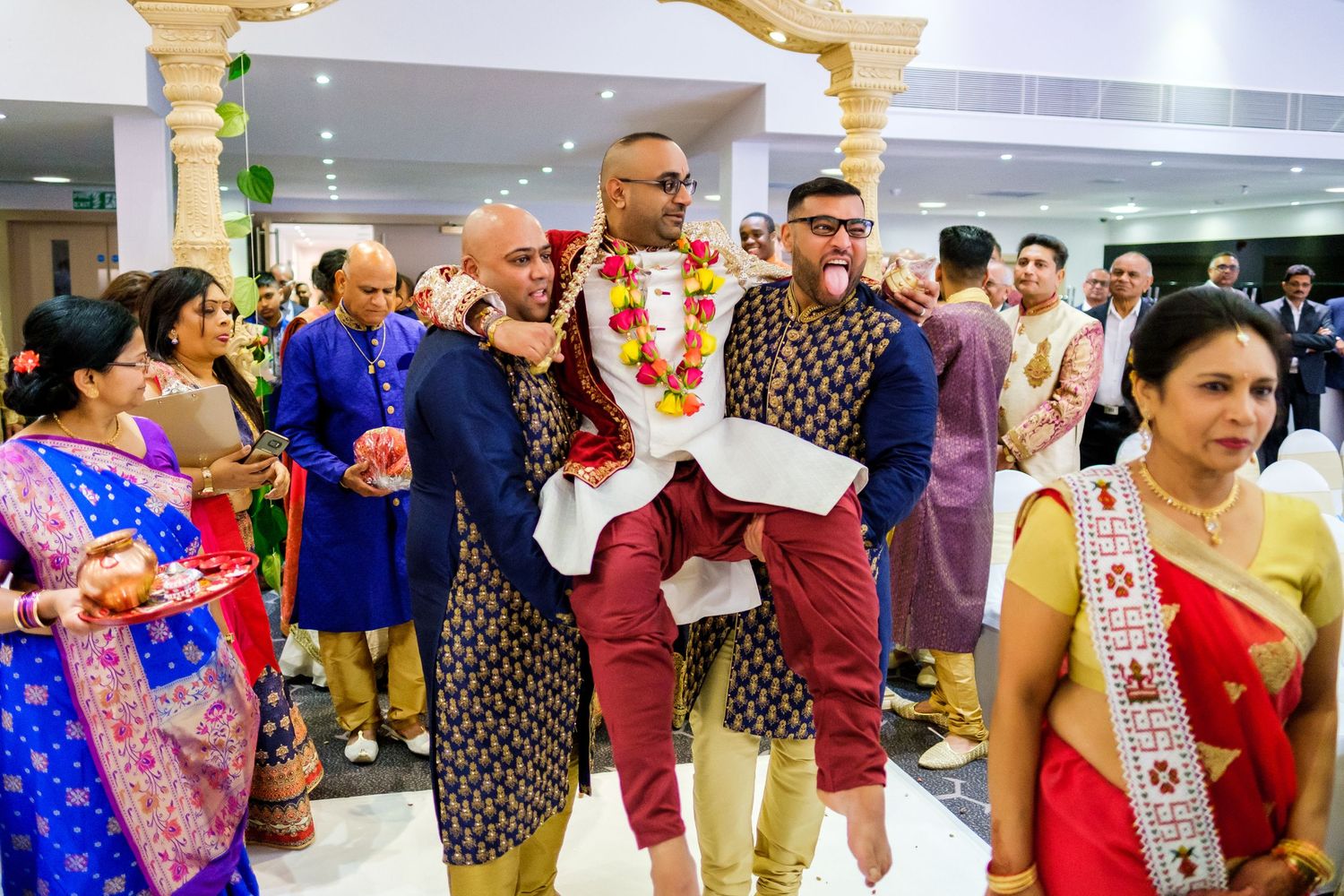 Wedding guests dancing and celebrating at a lively reception party.
