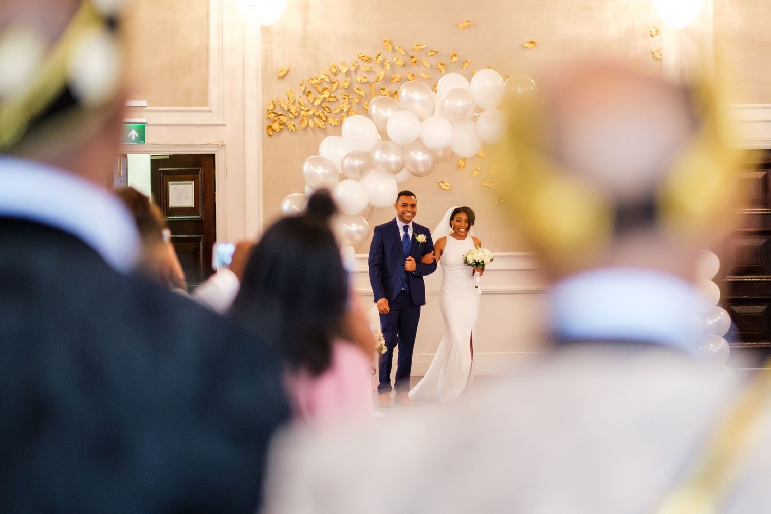 Guests gather in an elegant ballroom for a formal celebration.