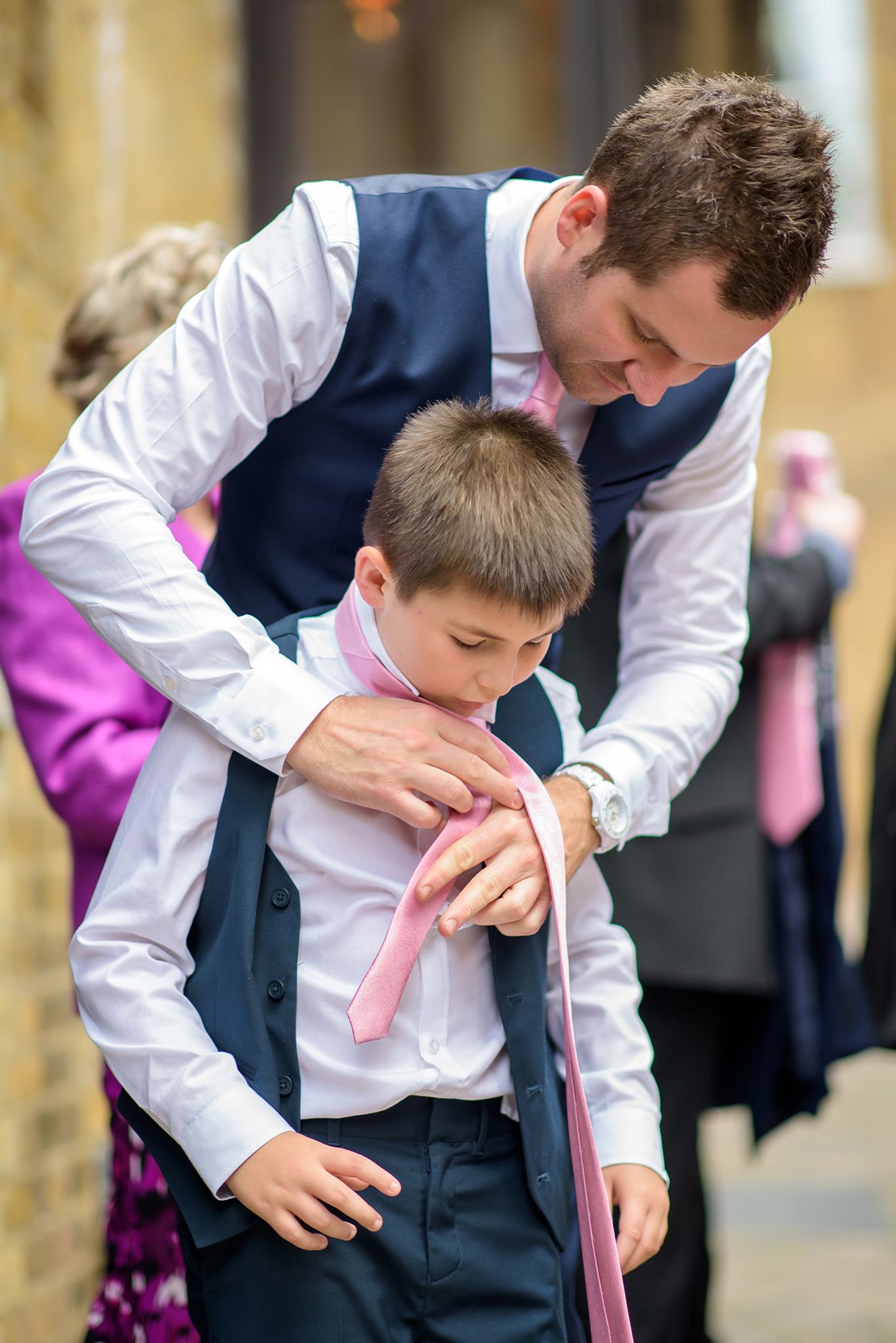 Wedding guest embraces and reacts emotionally during celebration at reception.