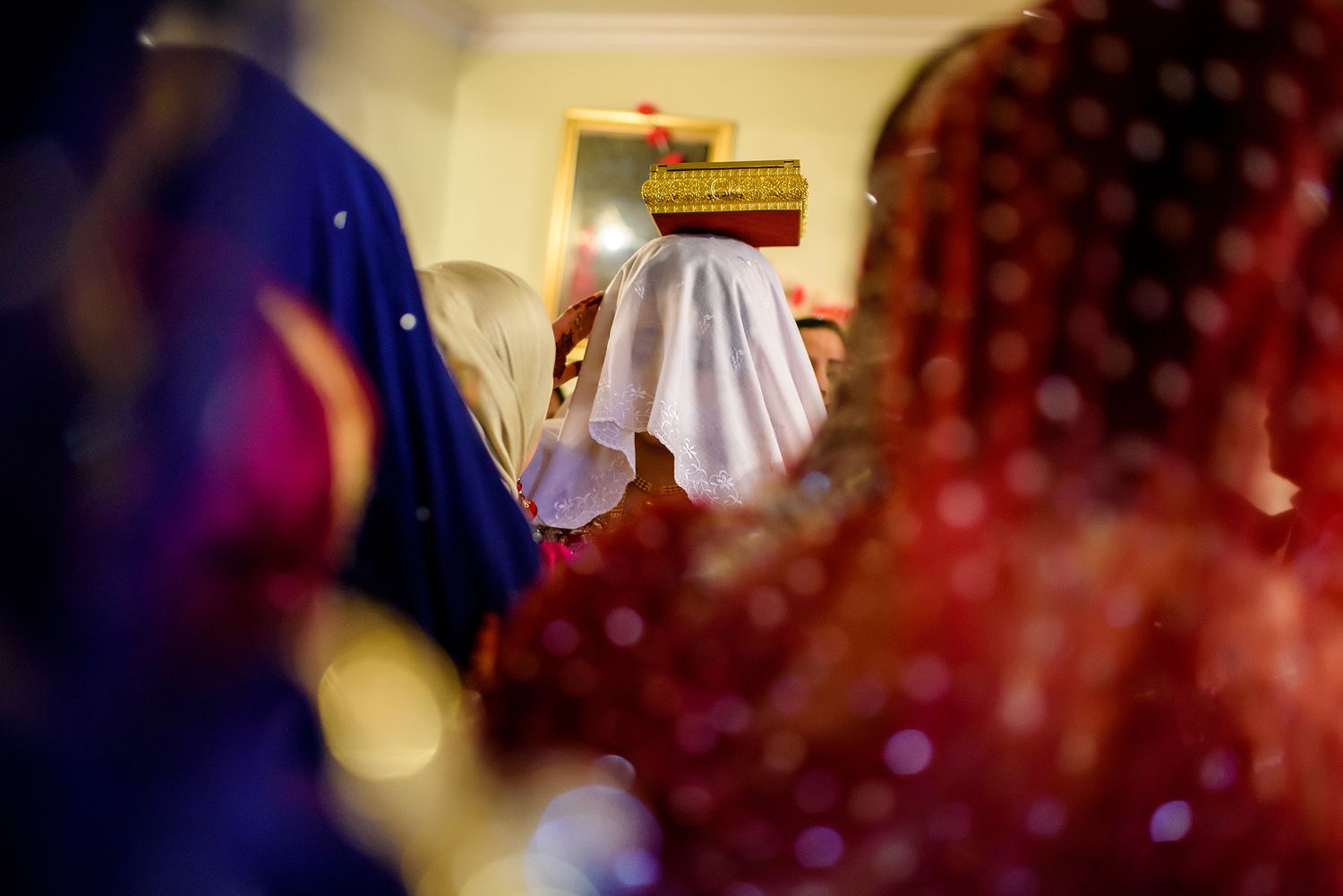 Blurred bokeh lights create atmospheric effect at evening wedding celebration.