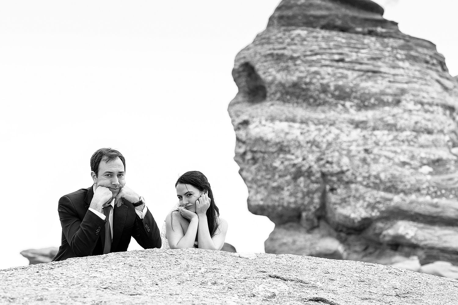 Black and white romantic portraits against dramatic rock formations.