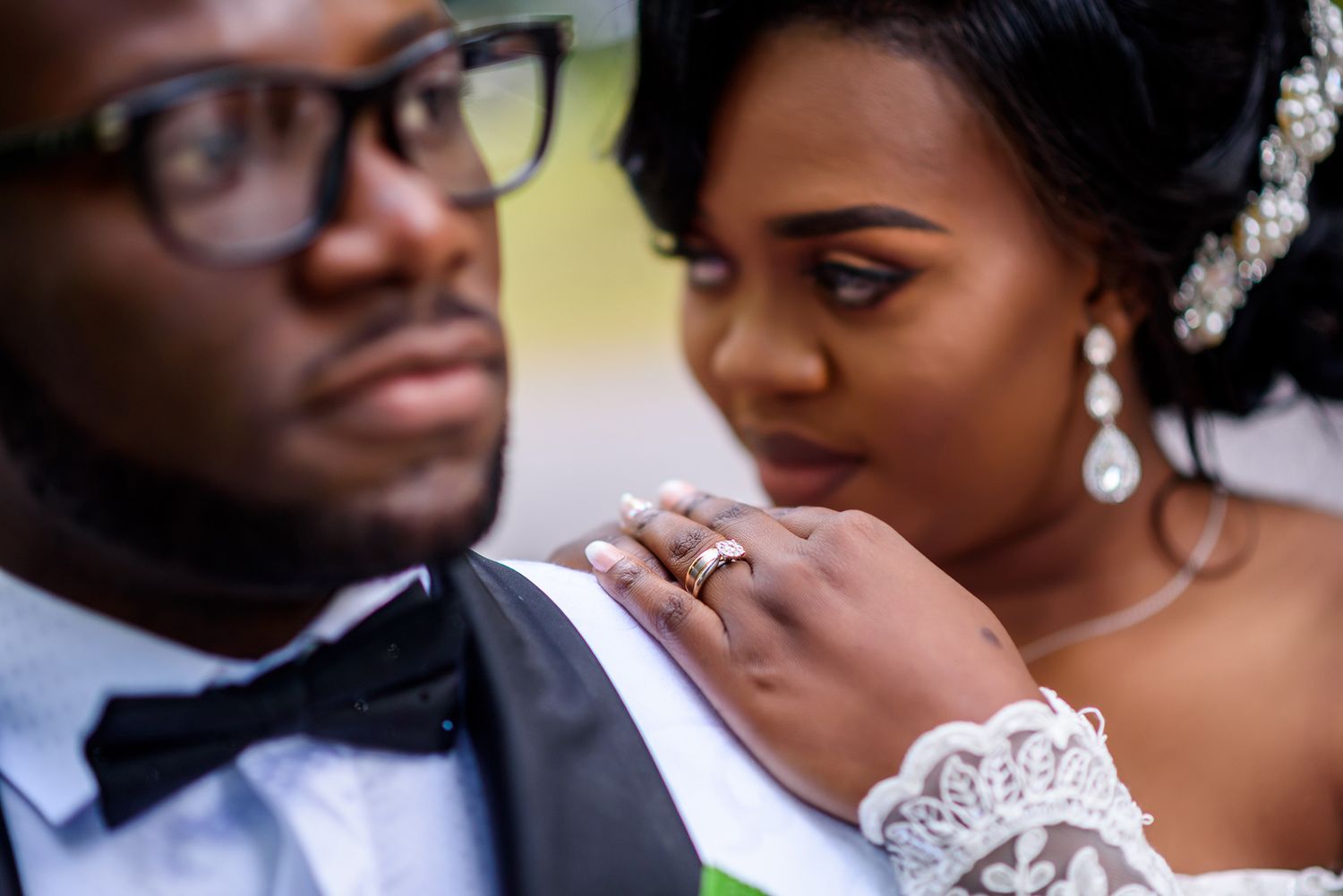 Elegant wedding couple sharing intimate close-up moments in formal attire.