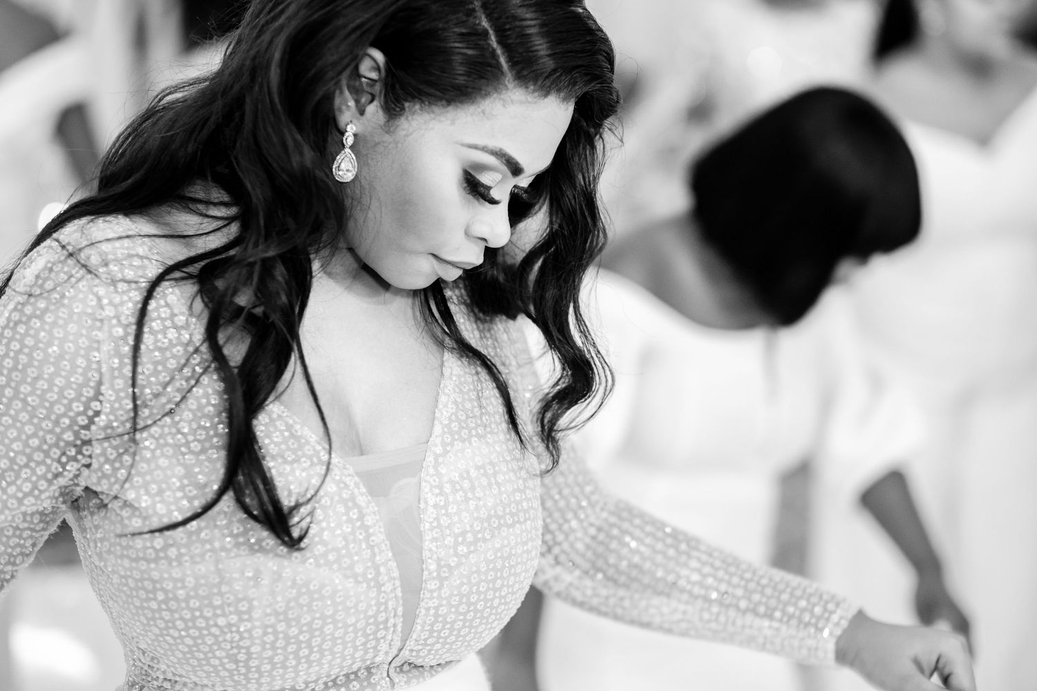 A romantic dance moment captured in black and white at an elegant wedding reception.