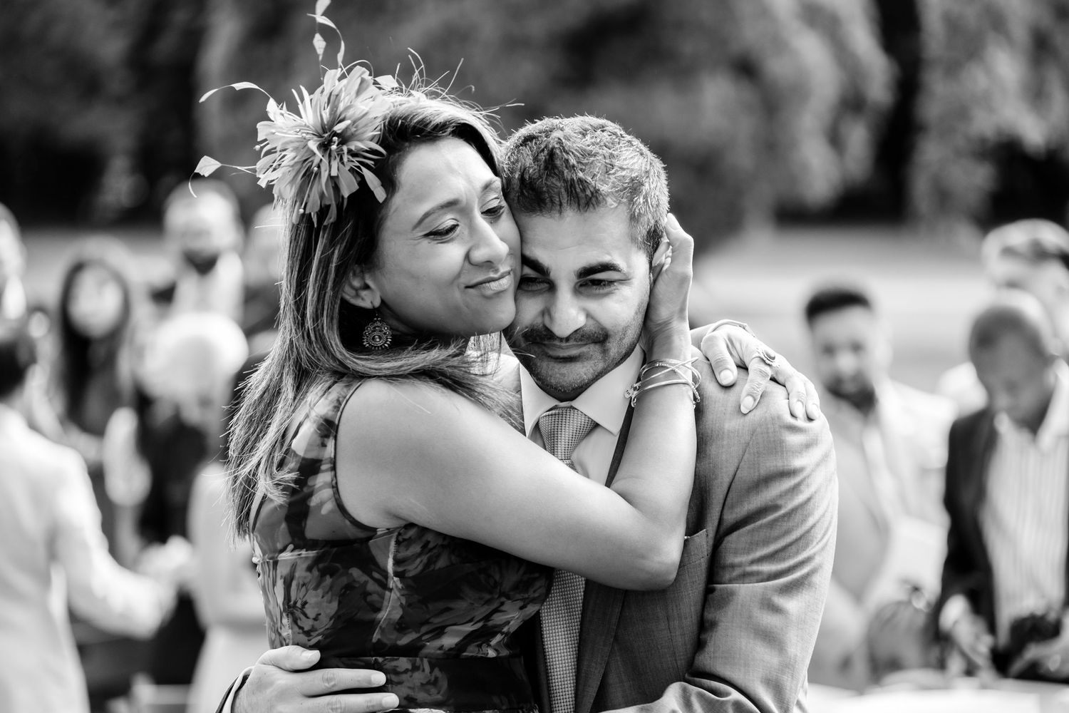 Candid black and white moments captured during wedding celebration.