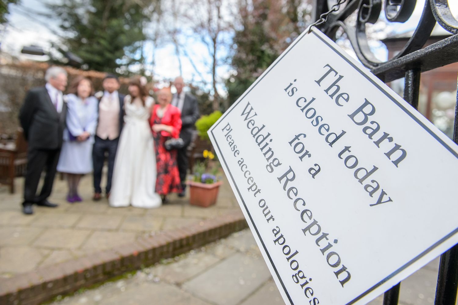 Decorative wedding signage displayed at outdoor venue entrance.
