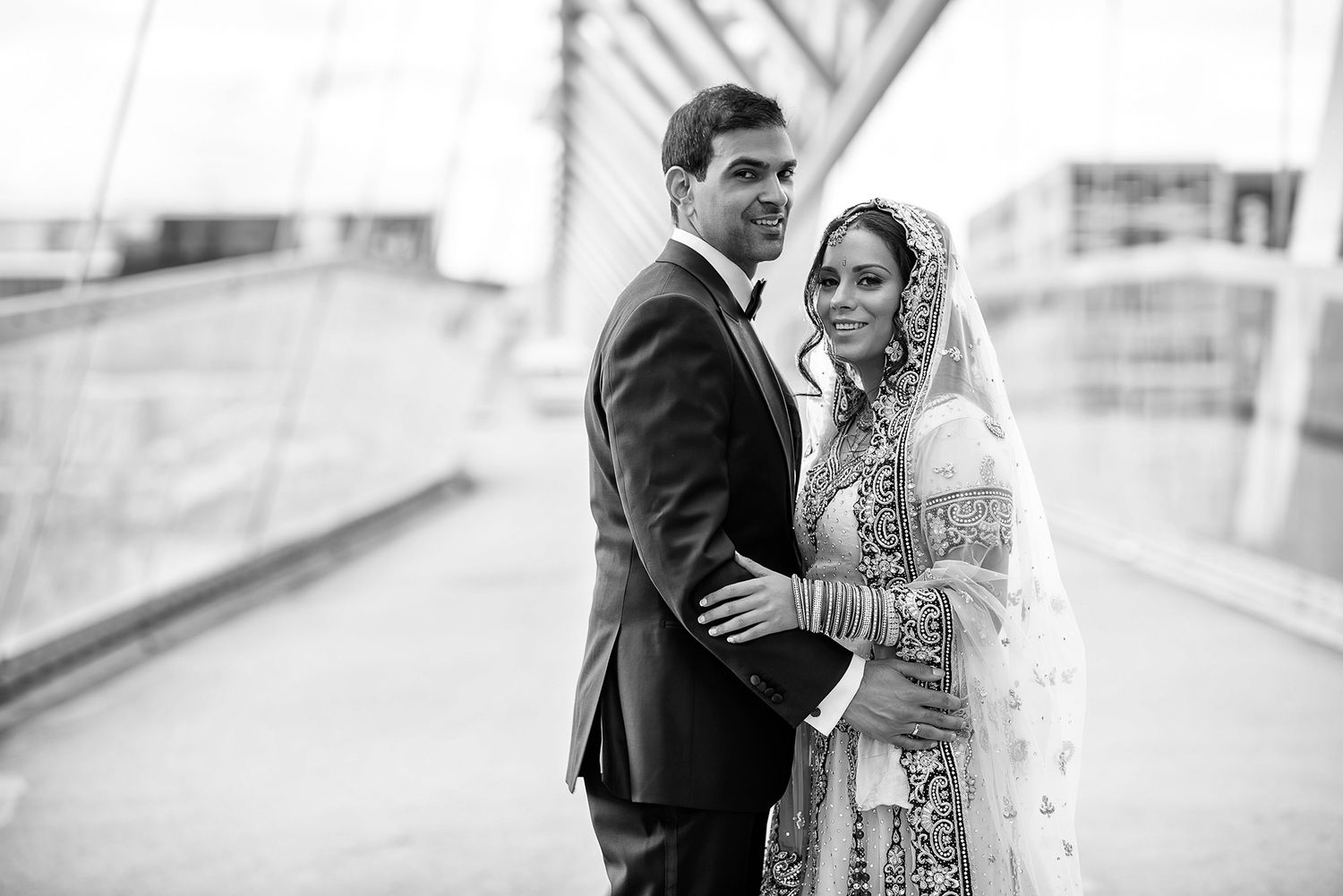 Black and white wedding portraits captured in an elegant outdoor setting.