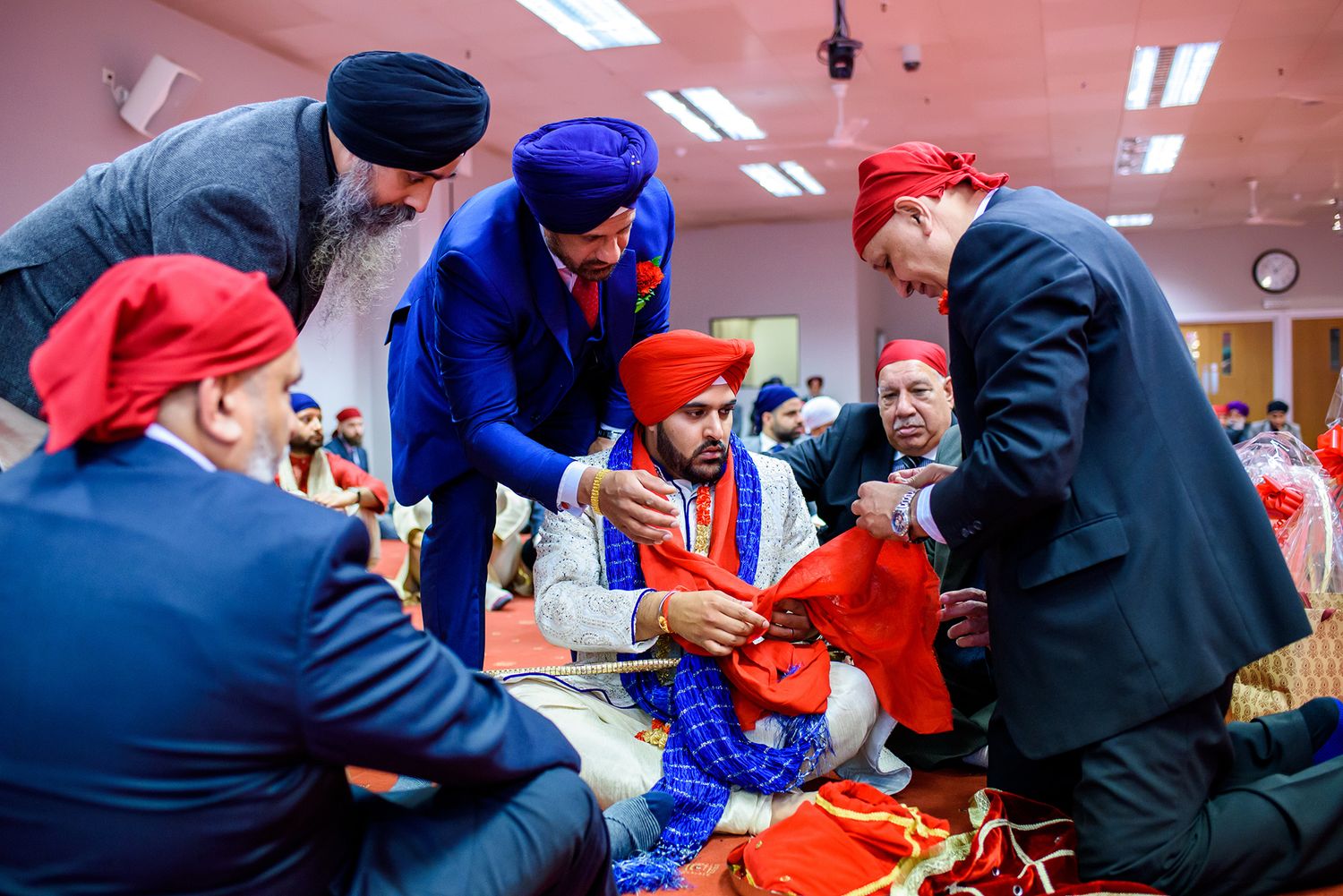 A group gathers around musicians performing at a traditional cultural celebration.