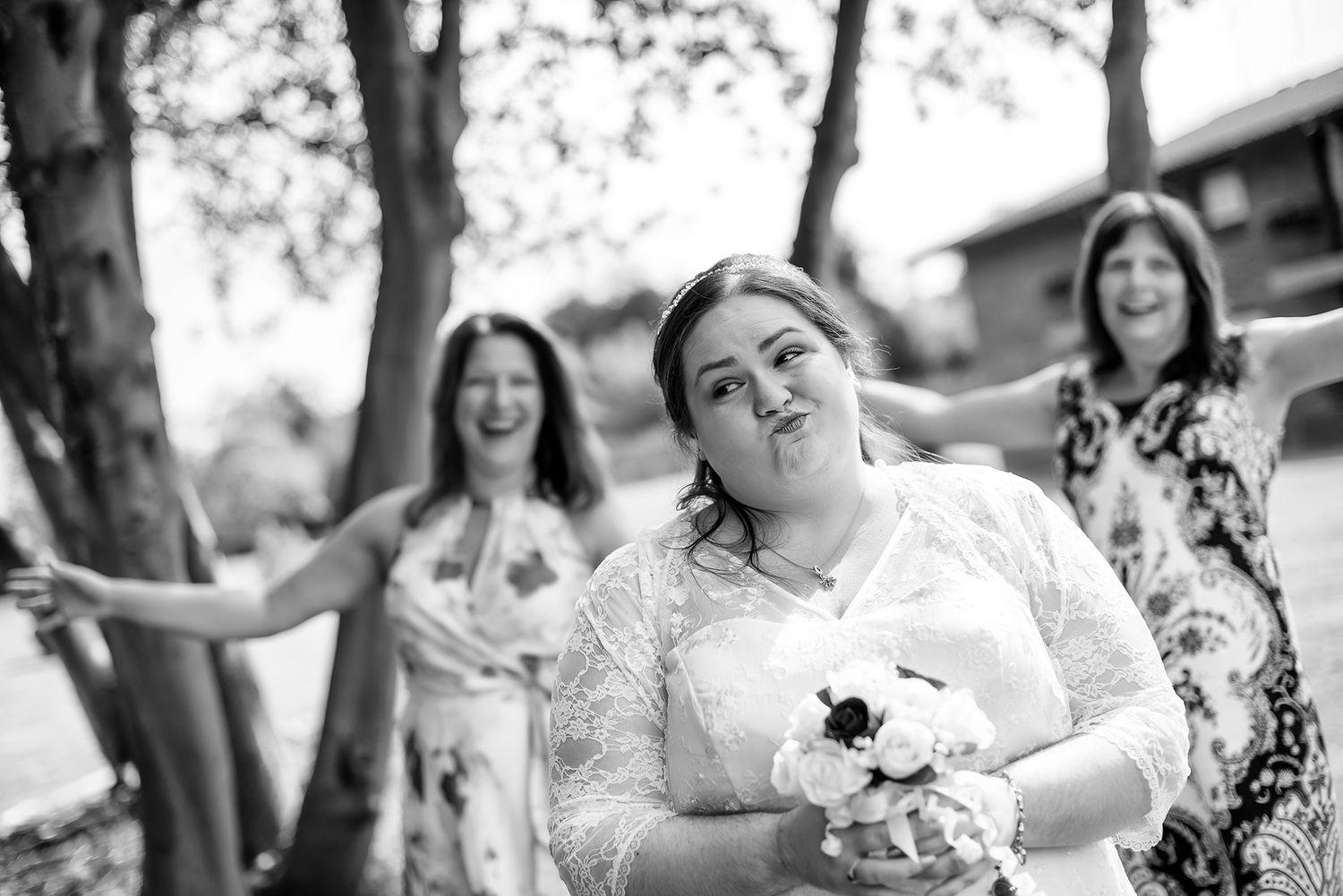 Black and white photo capturing candid moments of wedding celebration joy.