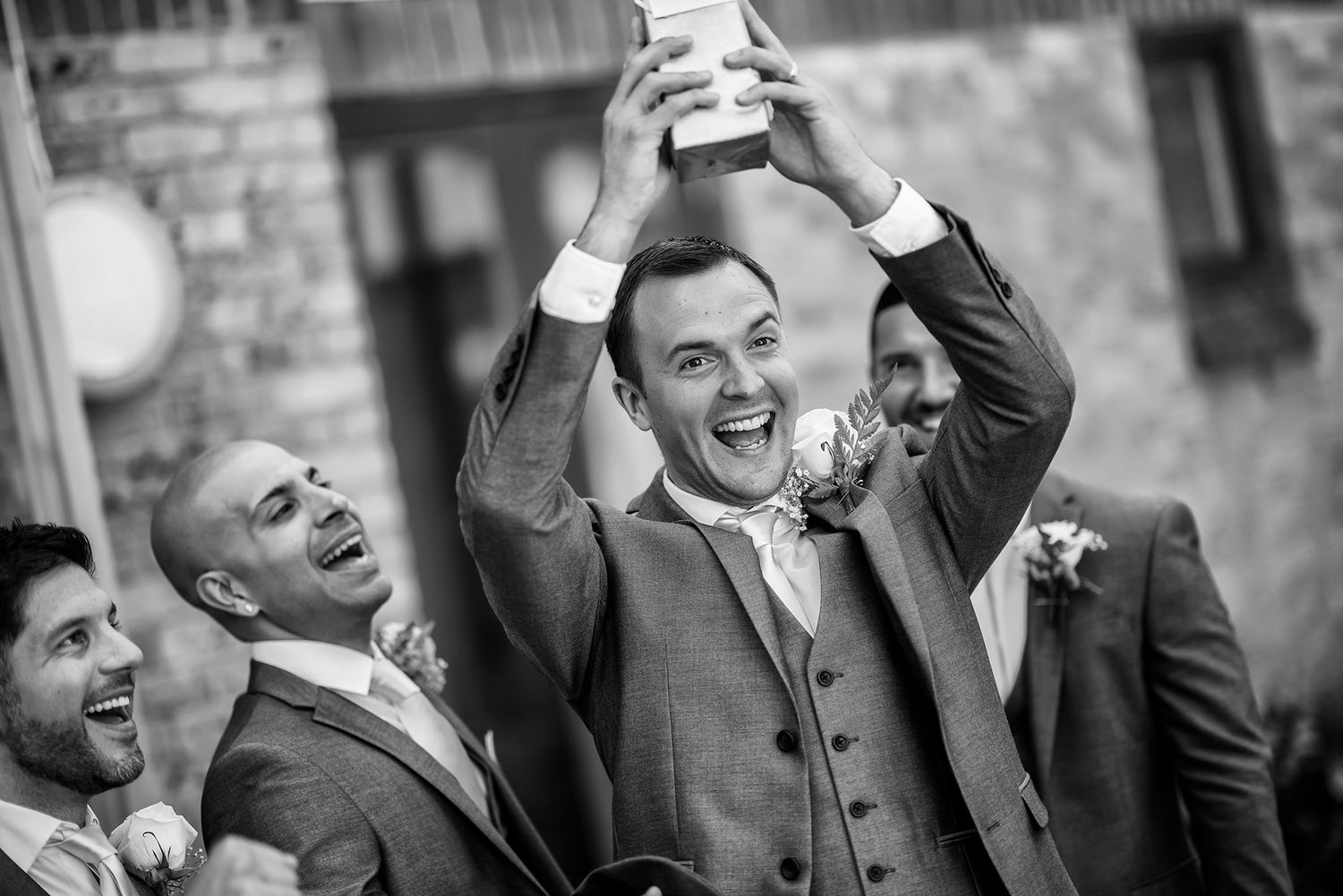Candid black and white shots showing laughter and joy at a wedding.