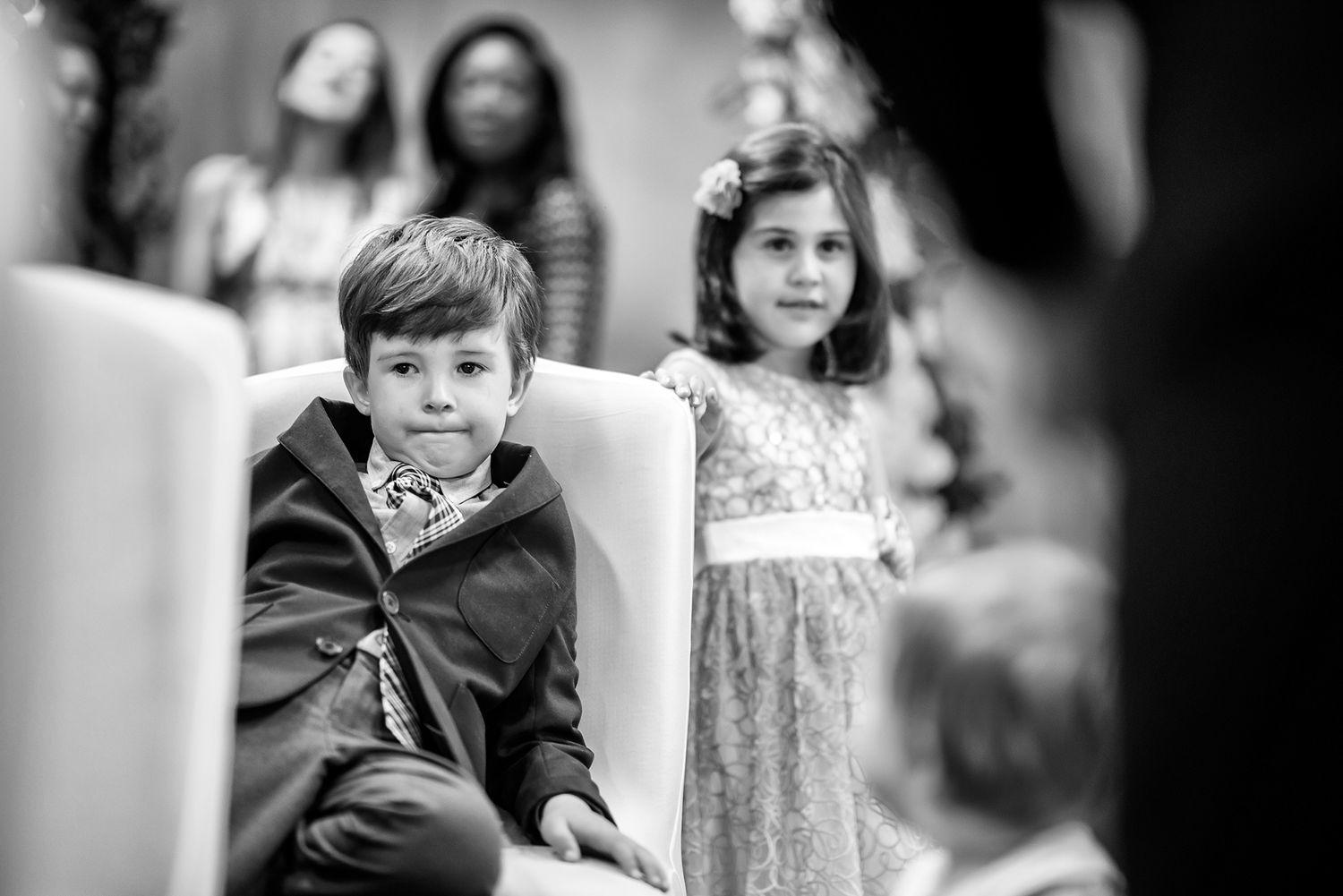 Black and white portrait of wedding guests during an intimate moment at the reception.