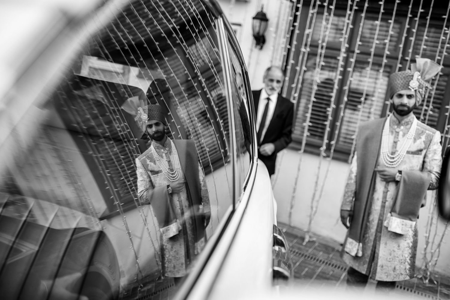 Black and white wedding photography capturing intimate moments through decorative elements.