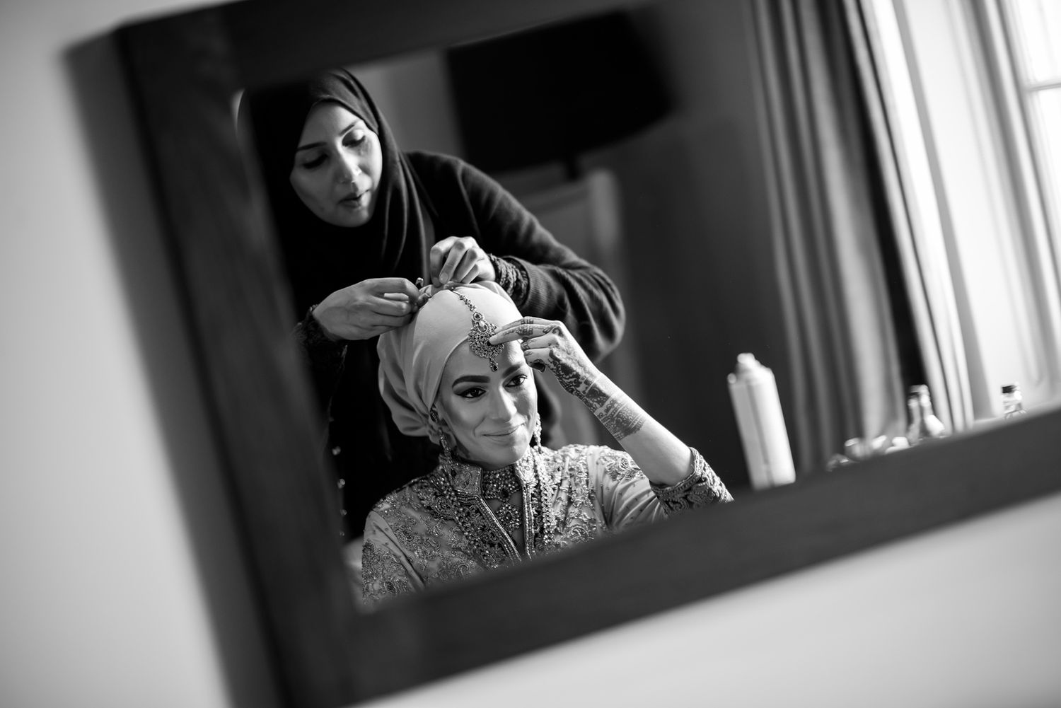 Black and white portrait series showing preparation moments in natural window light.