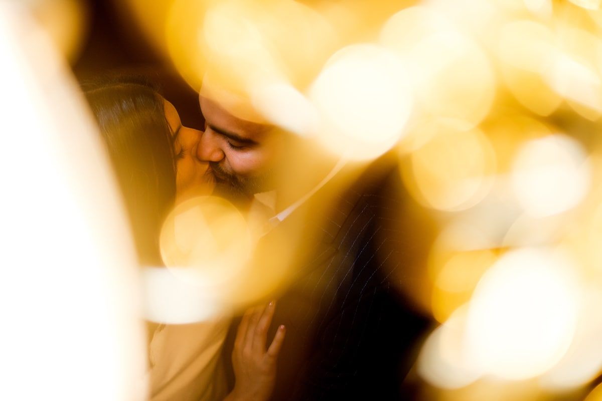 Abstract golden bokeh lights create dreamy wedding photography background.