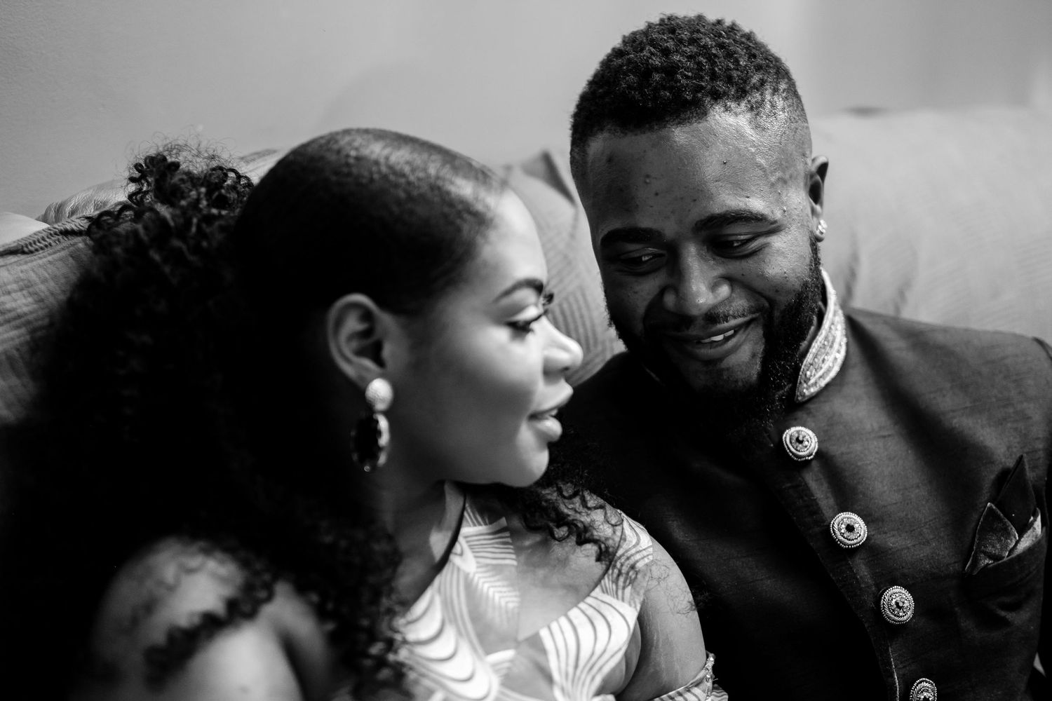 An intimate black and white portrait of a couple sharing a tender moment.
