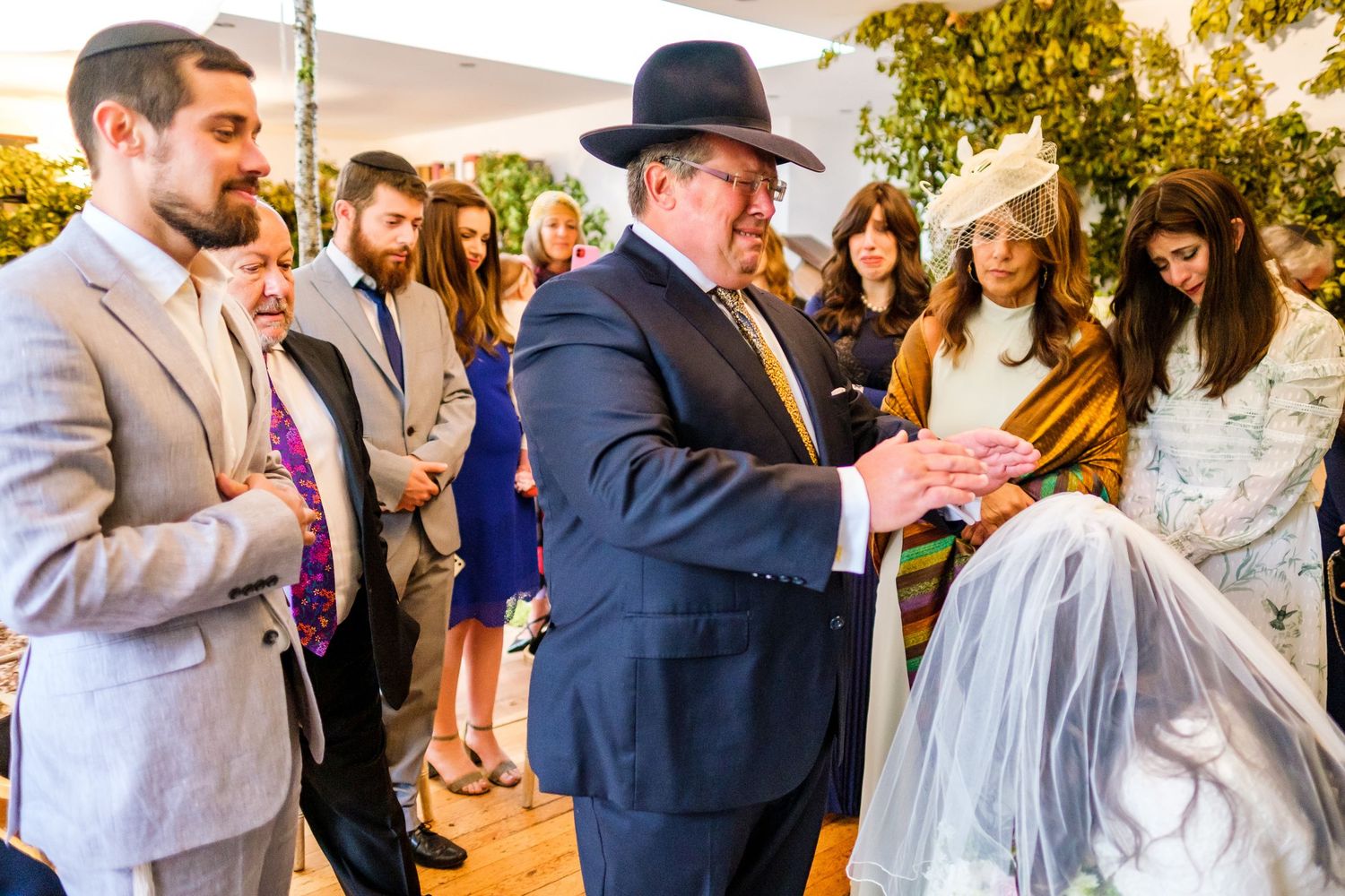 Wedding guests dance and celebrate together at an outdoor reception during golden hour.