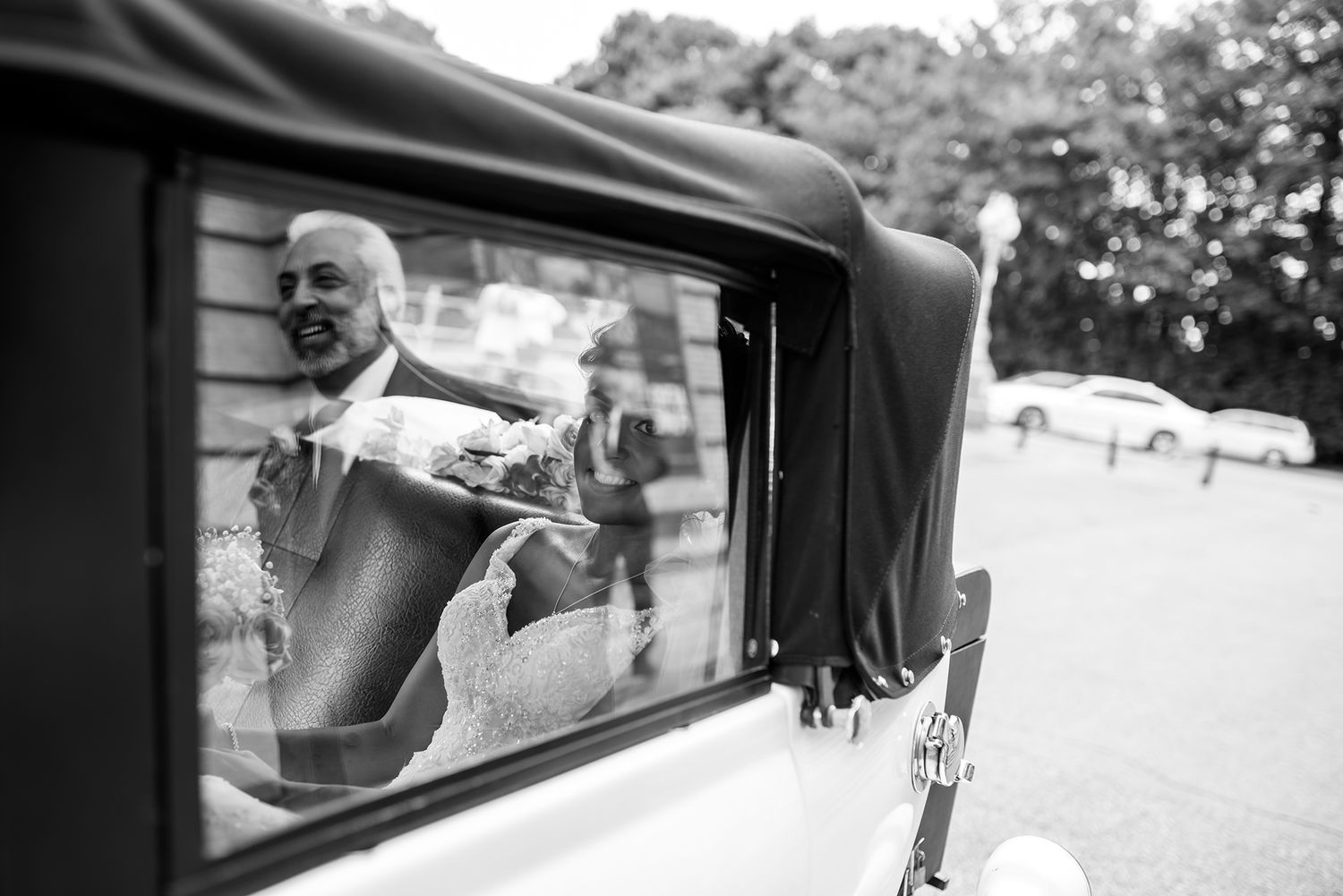 Wedding day emotional candid moments between couple arriving in vintage car.