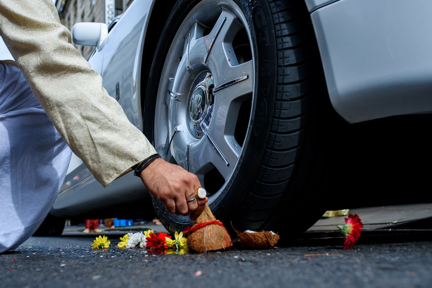 Close-up details of luxury car wheels and traditional Indian wedding attire.