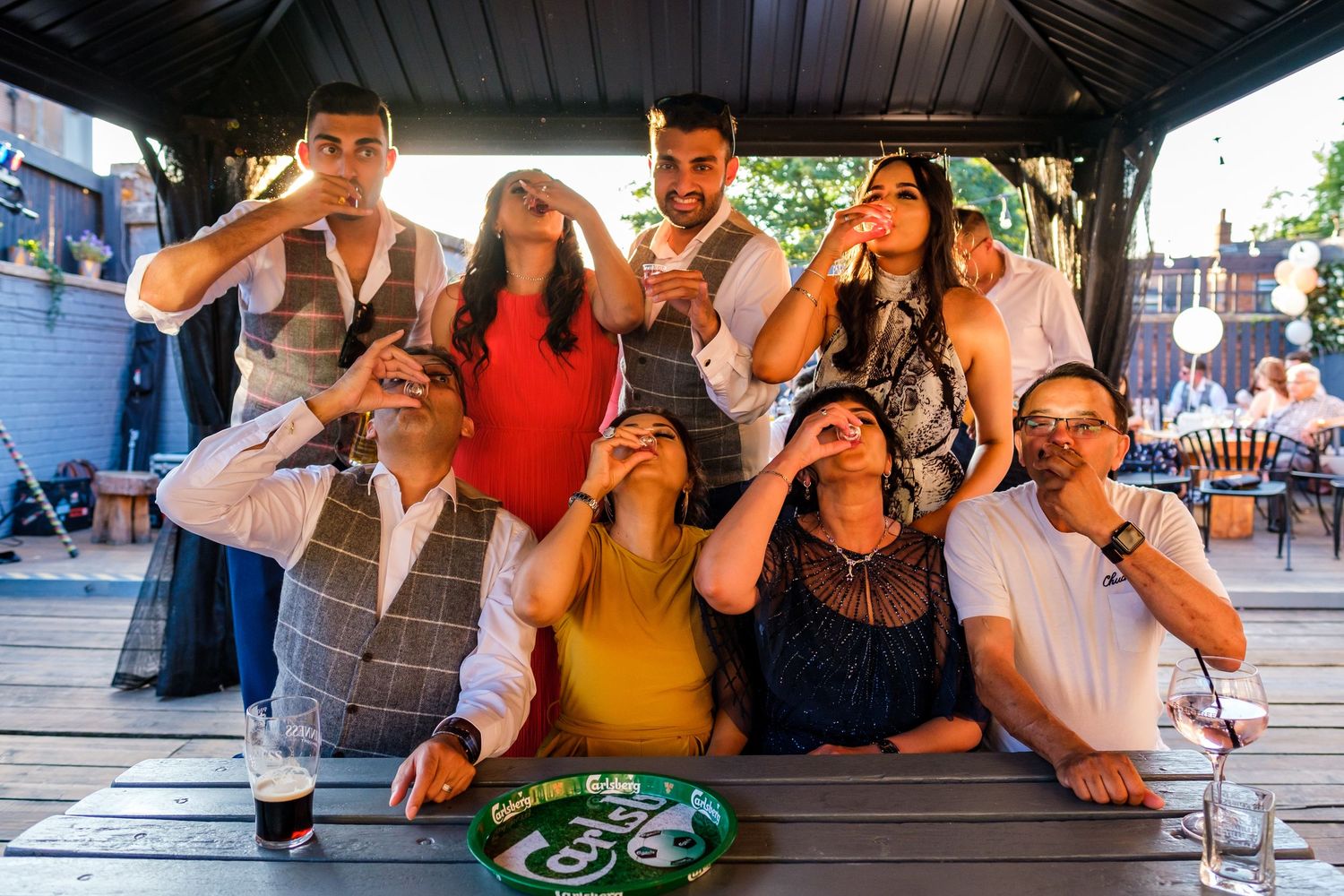 Group of friends enjoying drinks and socializing at a lively bar or restaurant gathering.