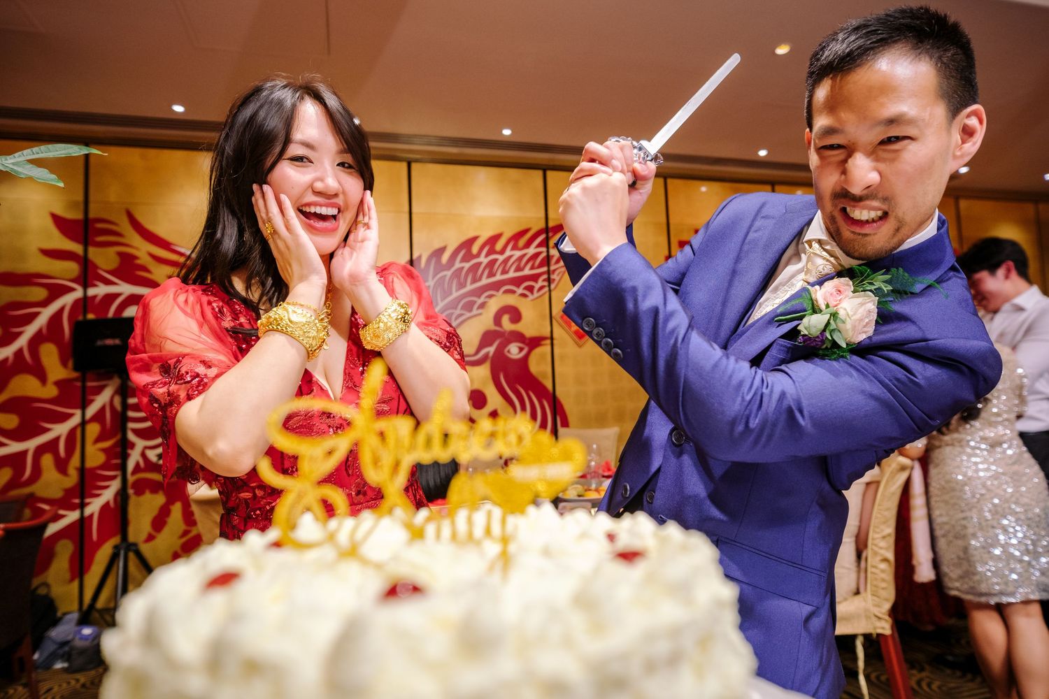 Guests celebrating with sparklers and cake at a festive Chinese restaurant gathering.