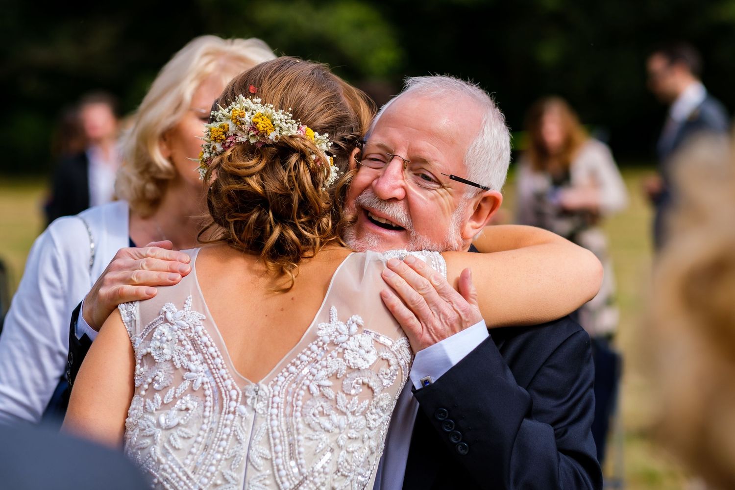 Emotional candid moments captured during an outdoor wedding celebration.