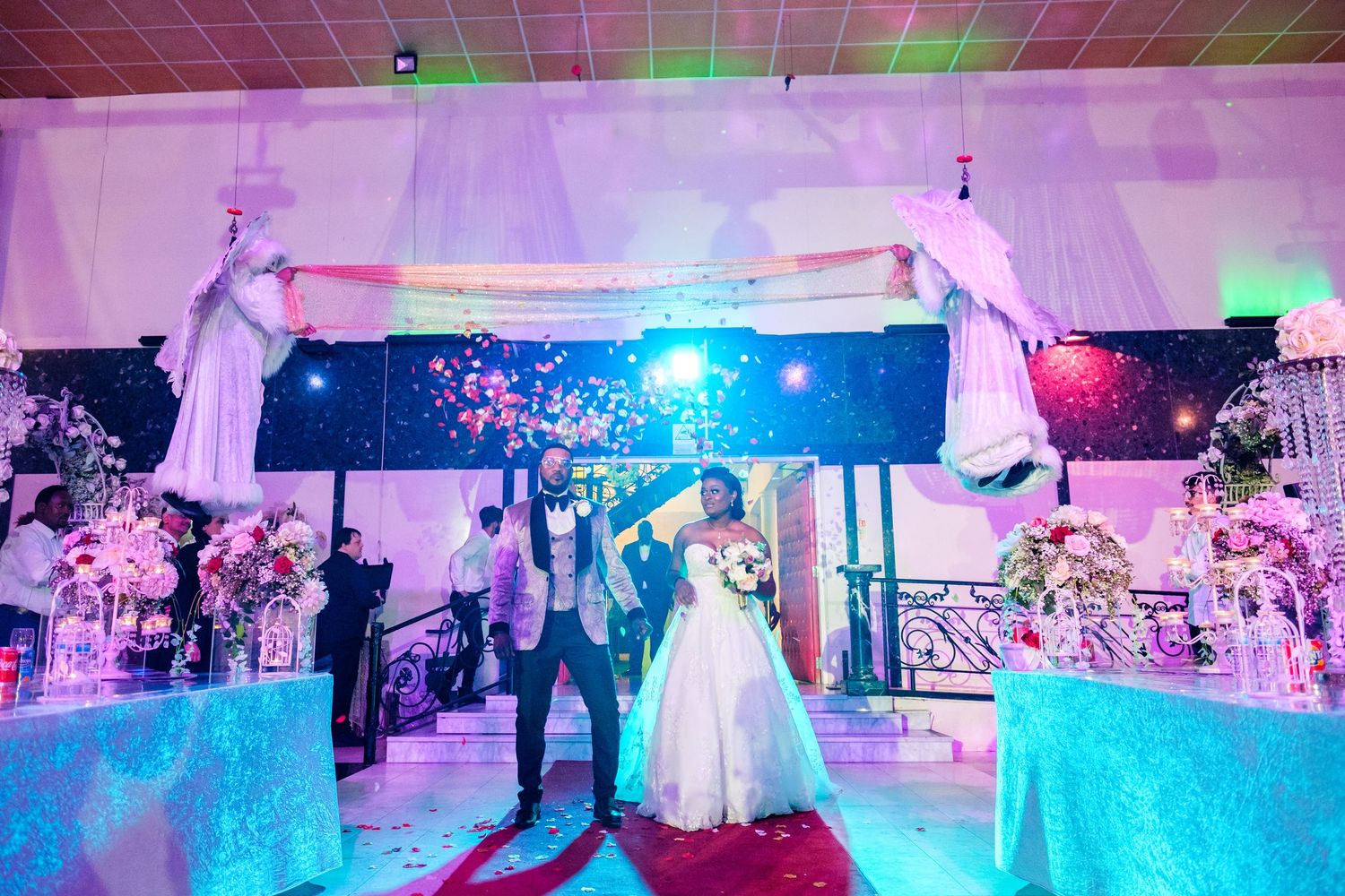 Wedding reception venue with colorful lighting and dance floor setup.