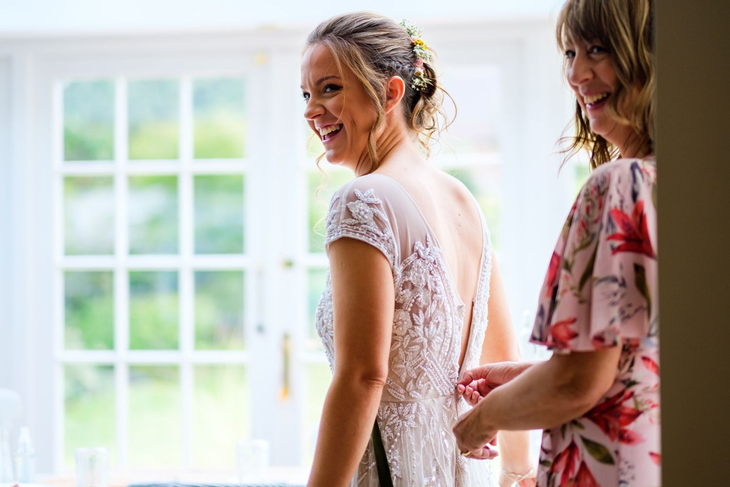 Wedding party members in floral and lace dresses prepare for the ceremony.