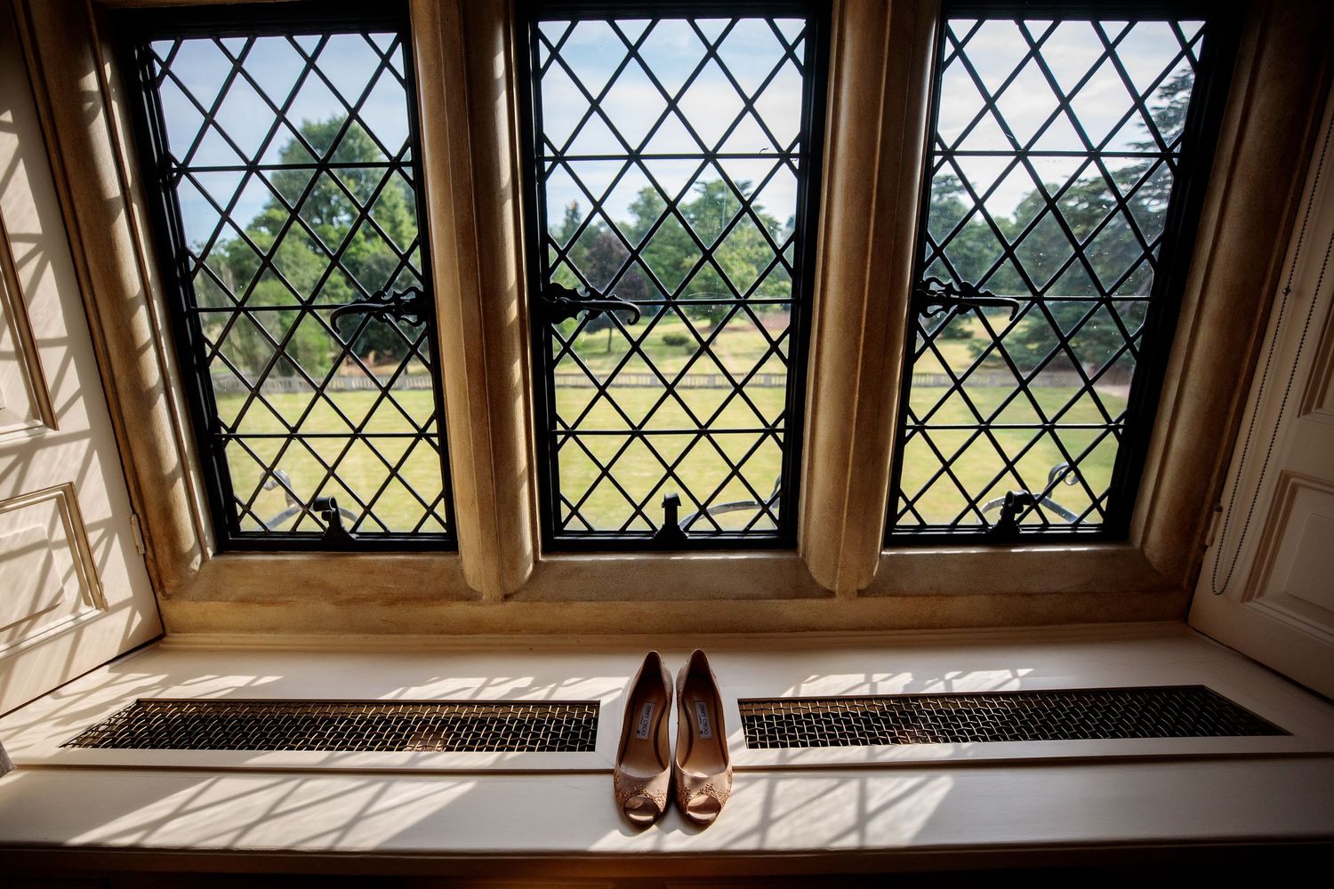 Ornate stained glass windows in a historic building let in natural light and create geometric patterns.