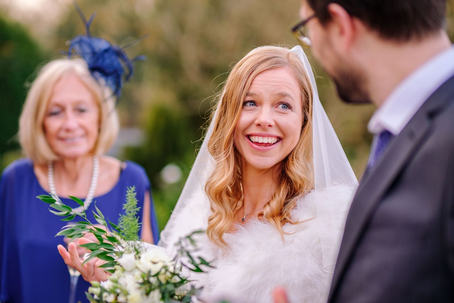 Outdoor wedding photography session with natural greenery in the background.