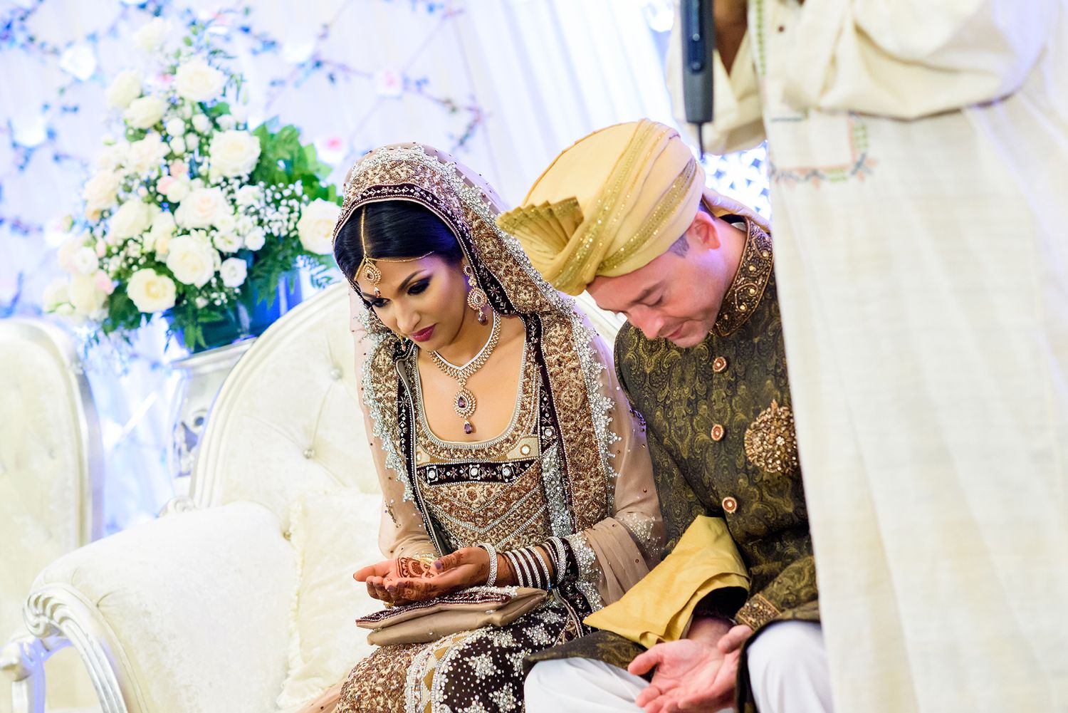 Traditional South Asian wedding ceremony with elaborate floral arrangements and decorative elements.