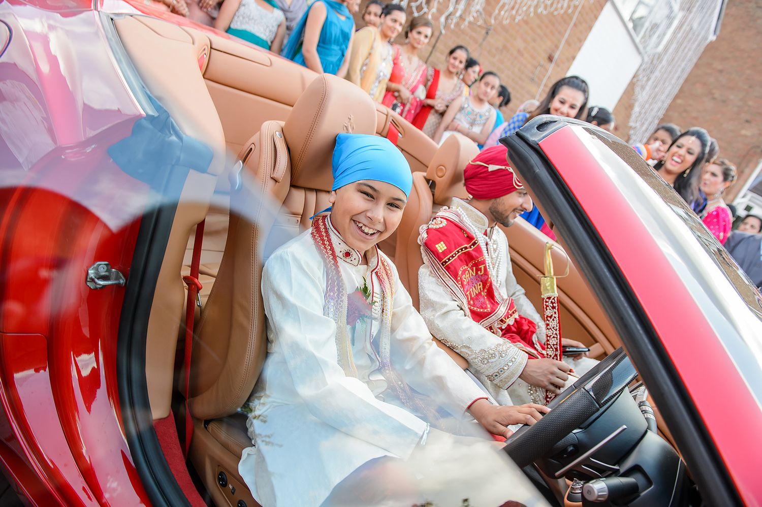 Red luxury Ferrari vehicle with wedding decorations.