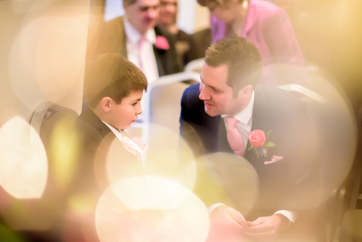 Soft focus wedding celebration moment with warm golden lighting.