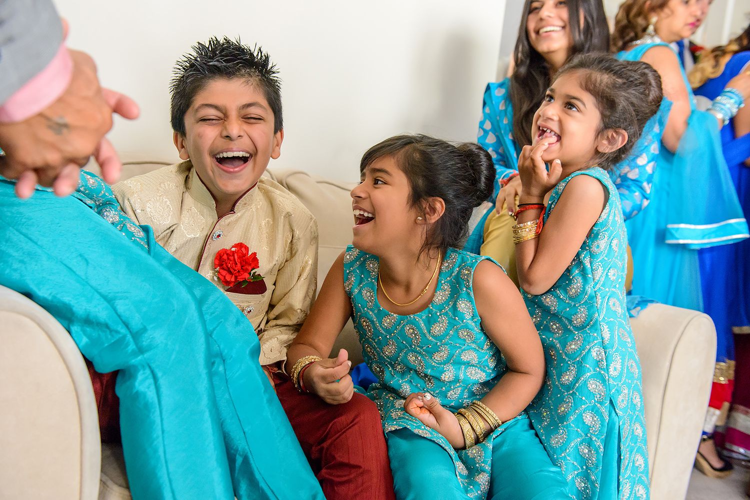 Joyful celebration with wedding party members in matching turquoise outfits.
