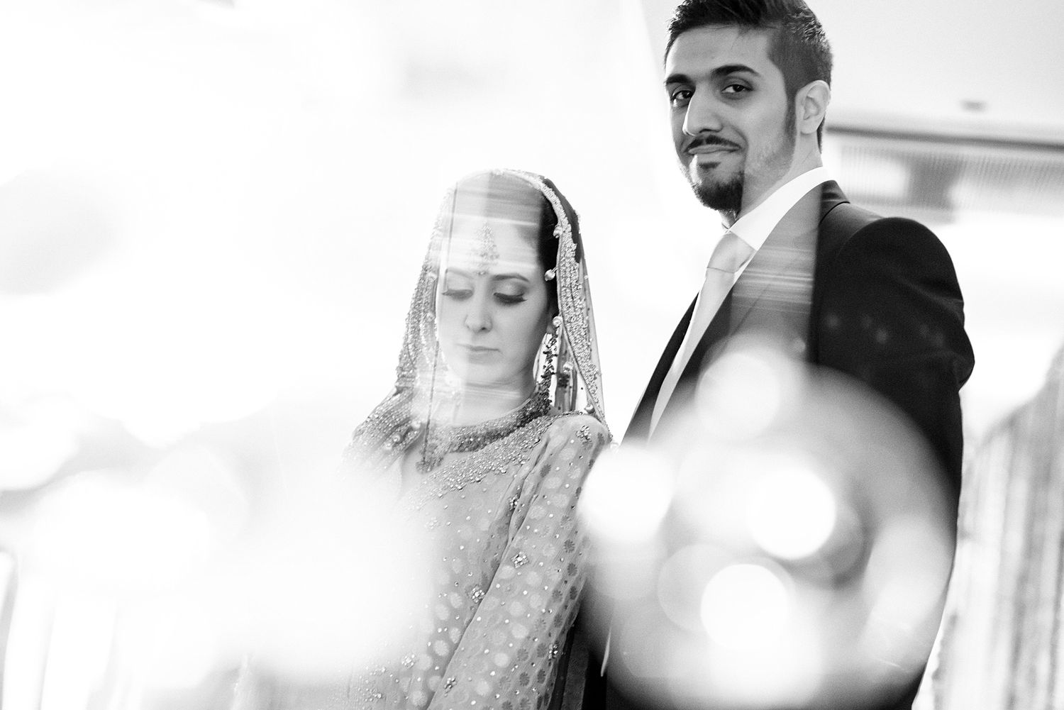 Candid black and white shots of wedding guests mingling at a reception.