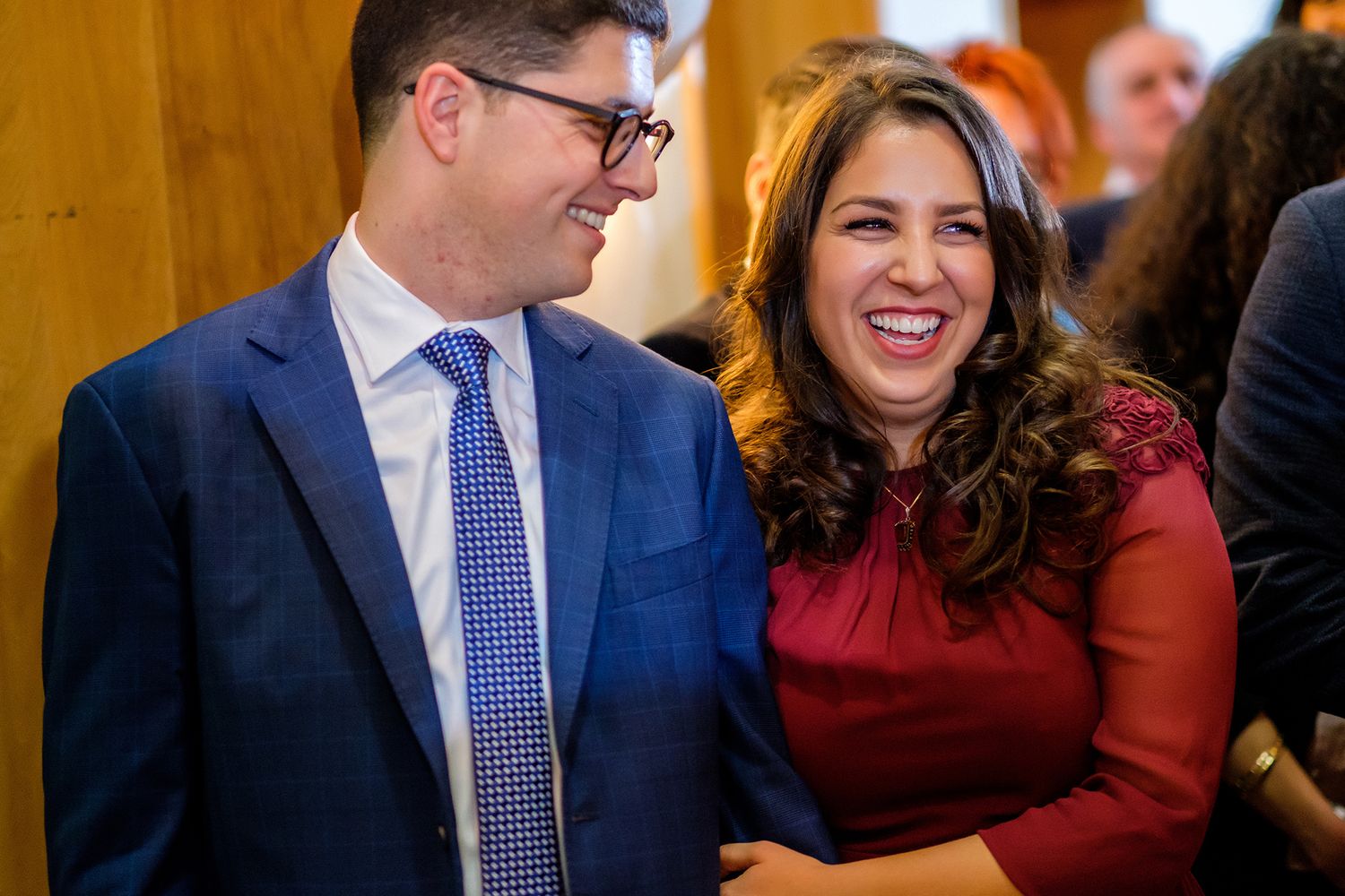 Business professionals engaged in lively conversation during a formal networking function.