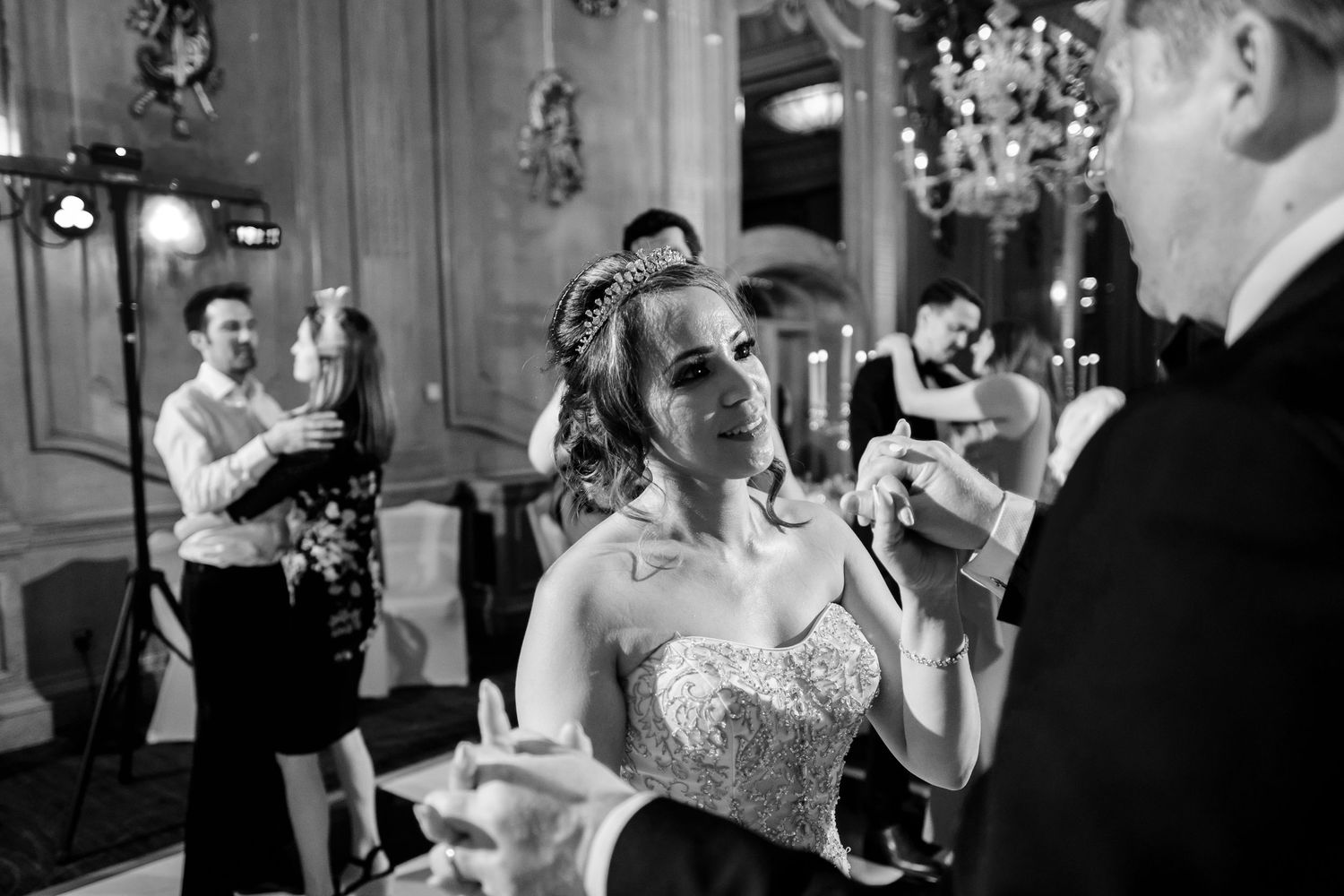 Black and white candid shots of wedding reception guests enjoying the celebration.