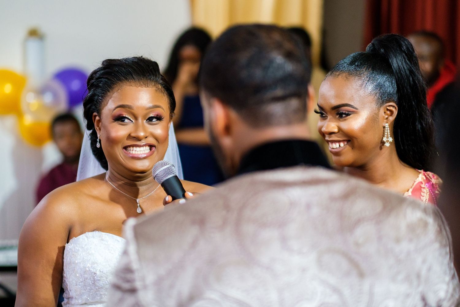 Wedding guests share joyful moments and laughter during an elegant reception celebration.
