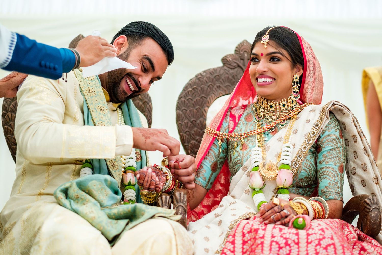 Couple in traditional Indian wedding attire sharing intimate moments during their ceremony celebration.