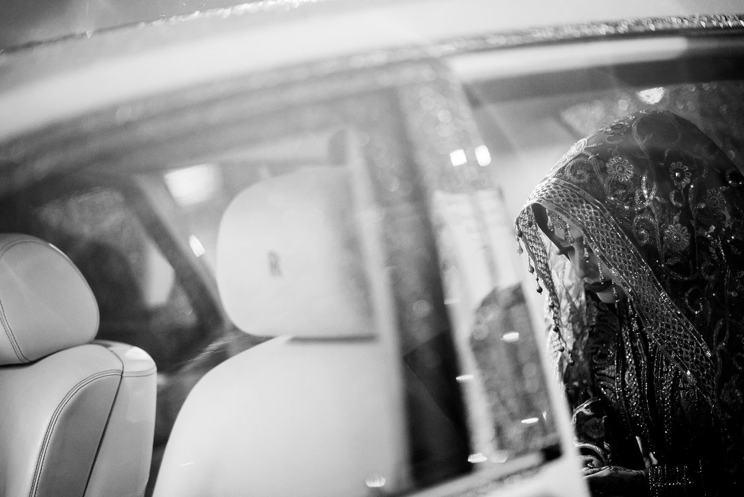 Artistic black and white detail shot of wedding venue lighting and decorations.