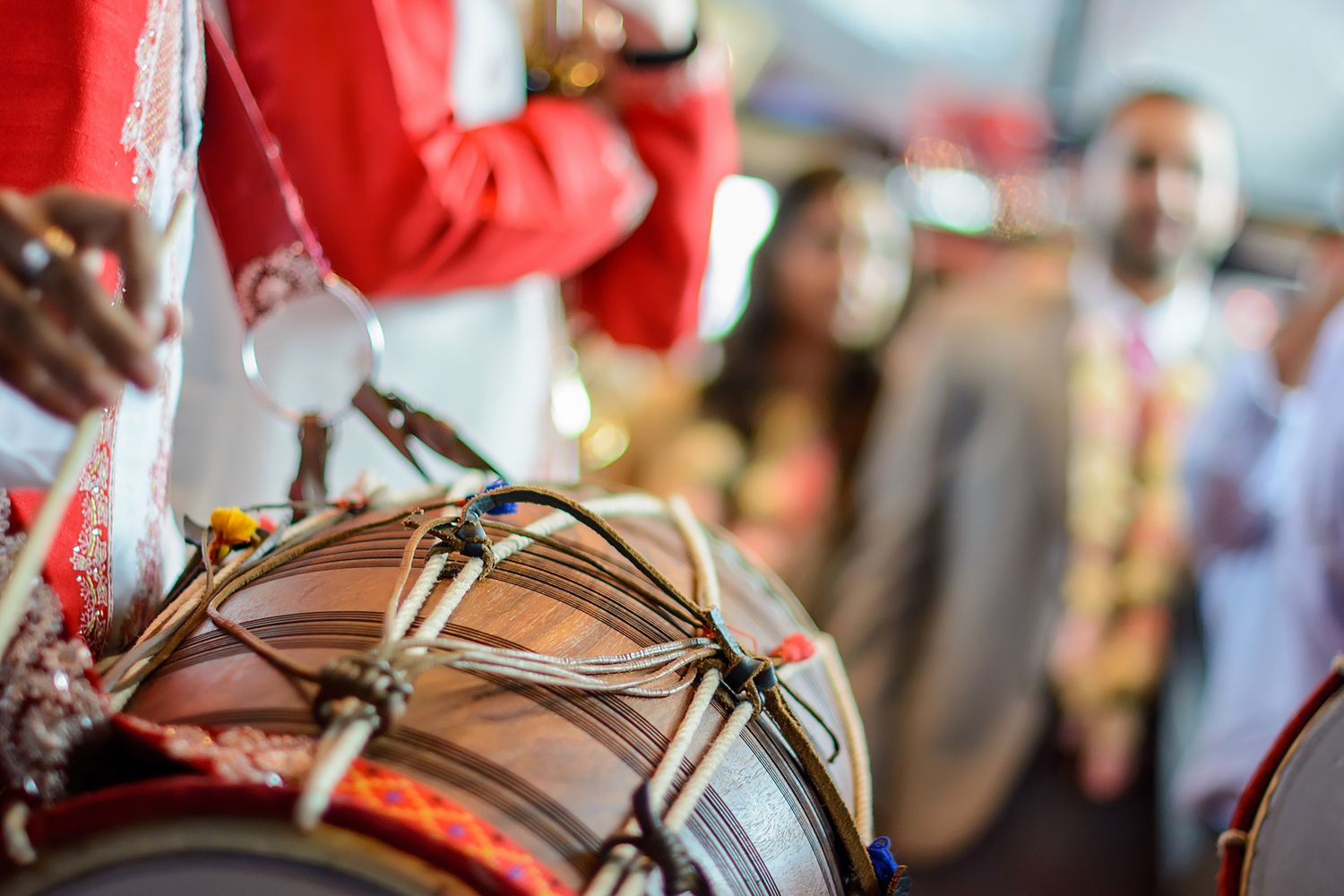 Decorative elements featuring red fabrics and traditional wedding accessories.