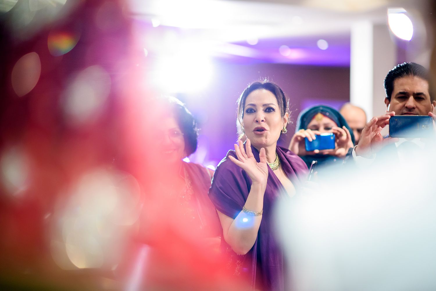 Wedding celebration captured with bokeh effects and ambient lighting.