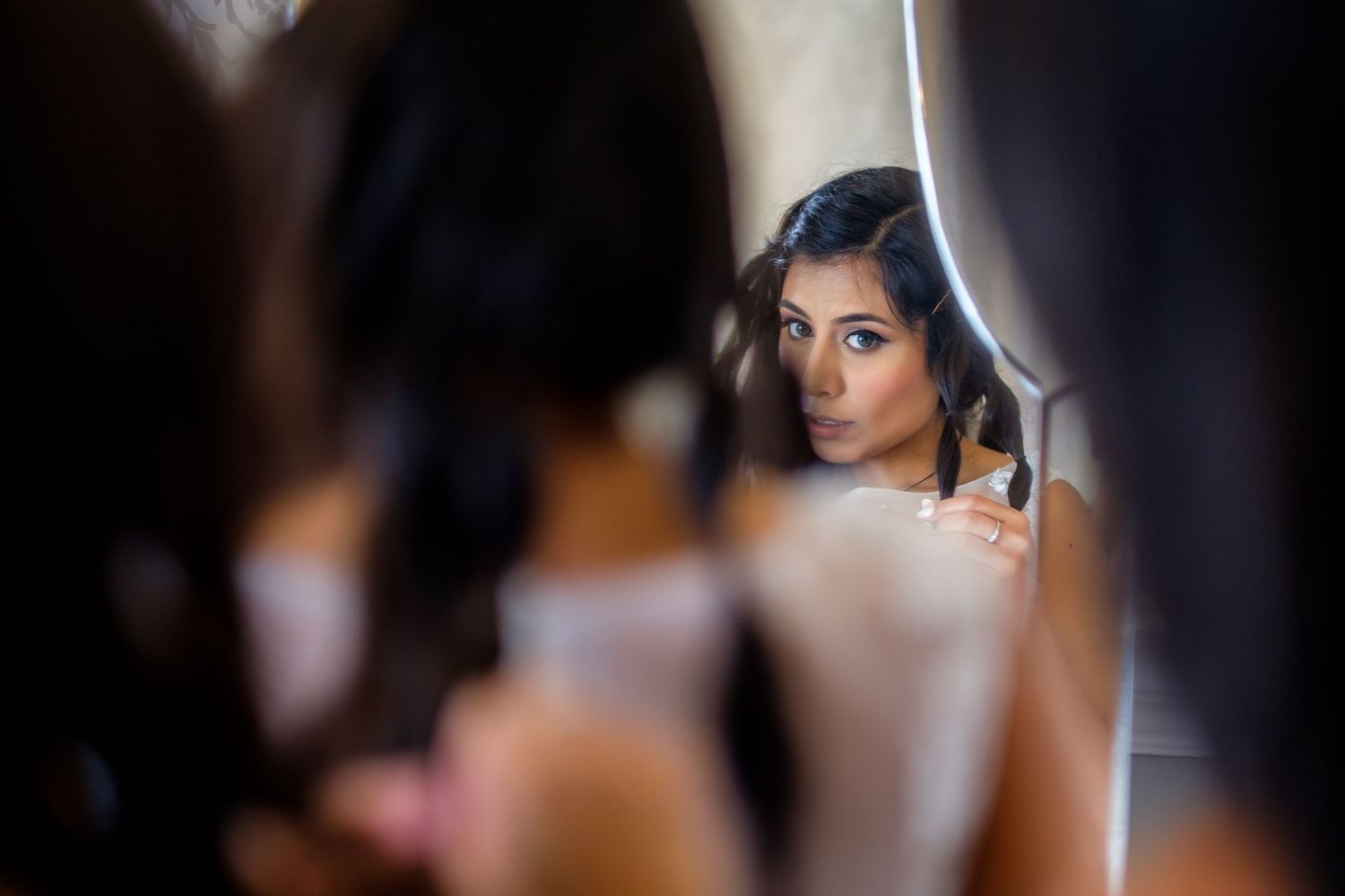 Getting ready scenes show bridesmaids in elegant black dresses preparing for the ceremony.