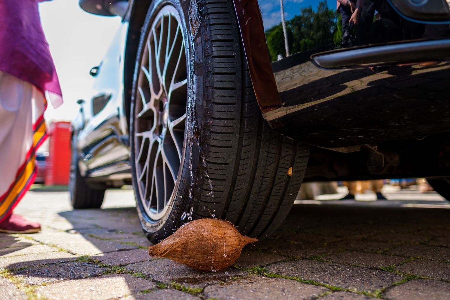Close-up view of car tires and wheels at an outdoor event.