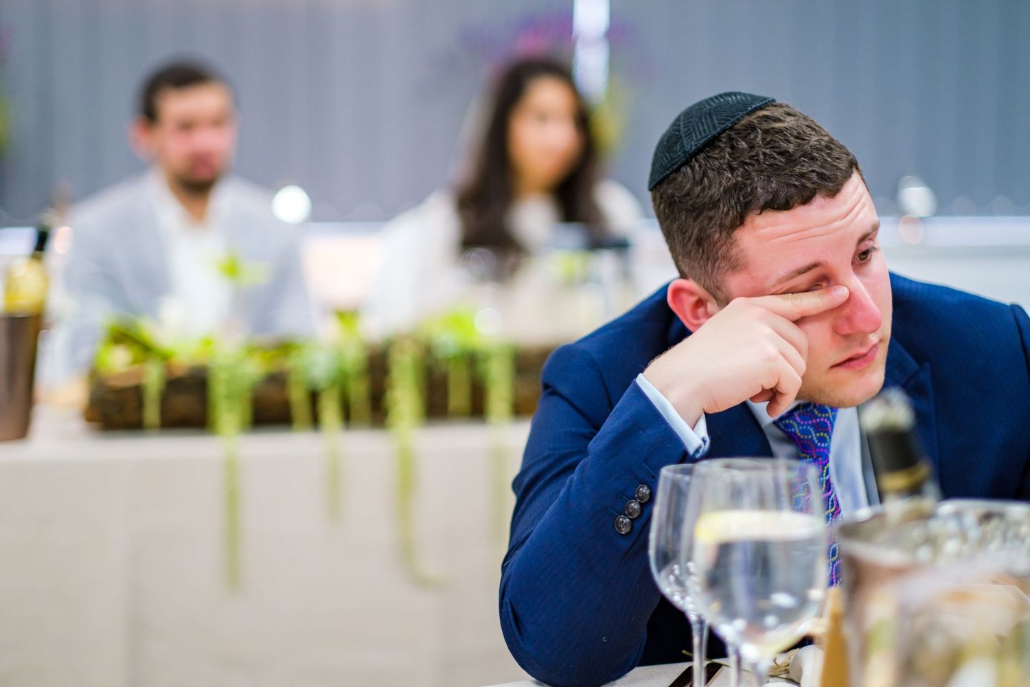 Guests enjoying themselves with laughter and conversation during a wedding reception.