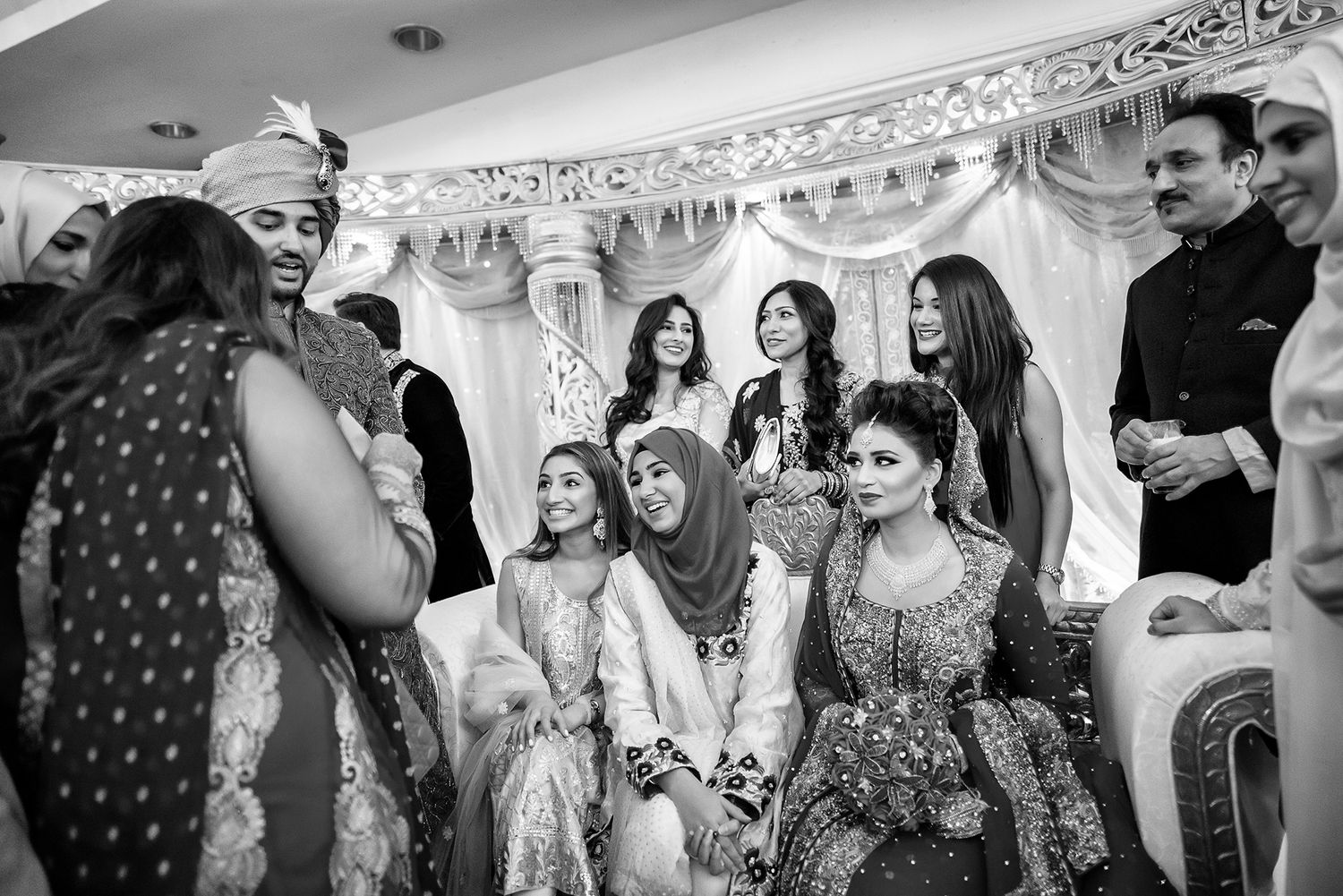 Wedding guests mingle and socialize during an elegant indoor reception.