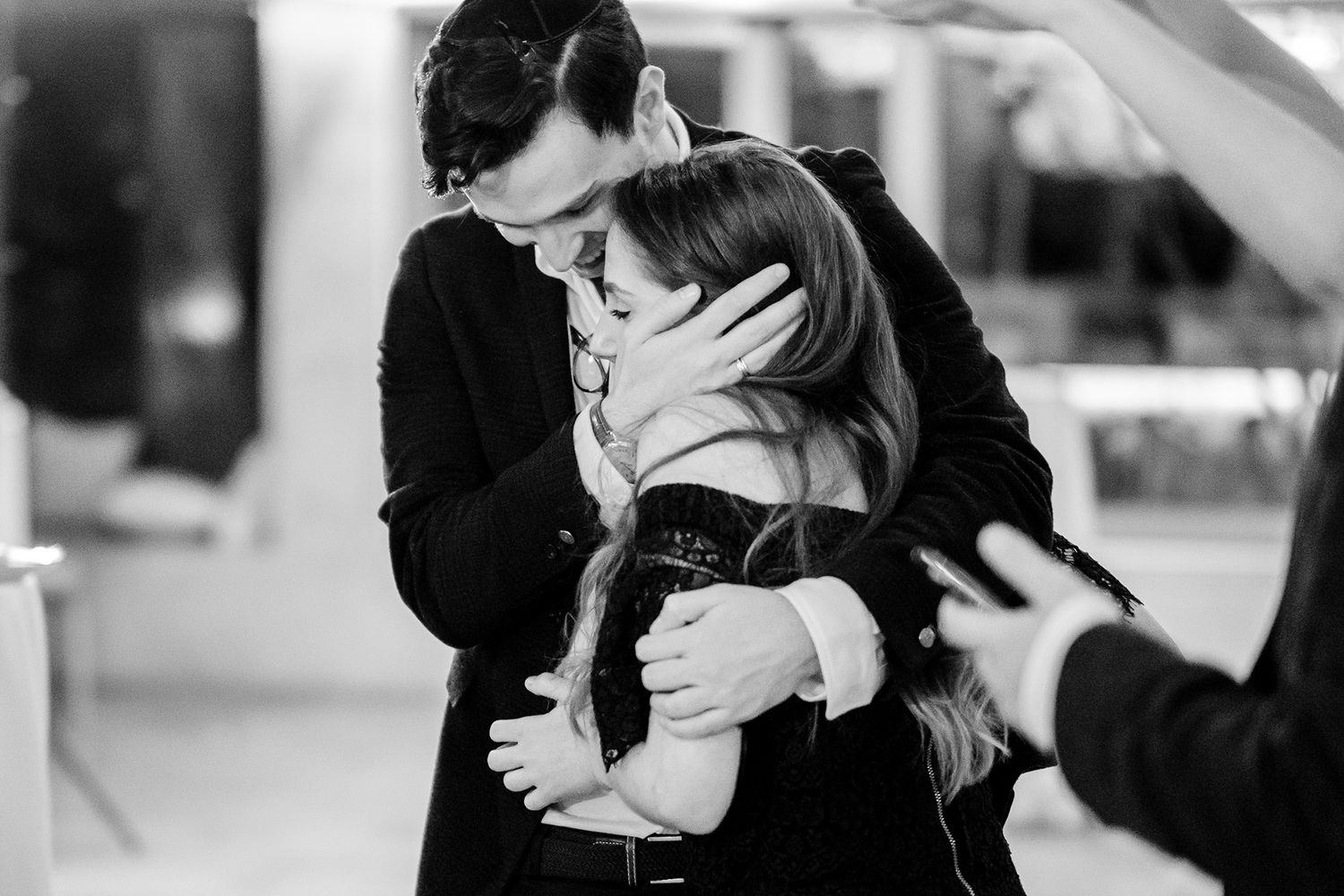 Black and white photo of couples dancing closely at an elegant celebration.