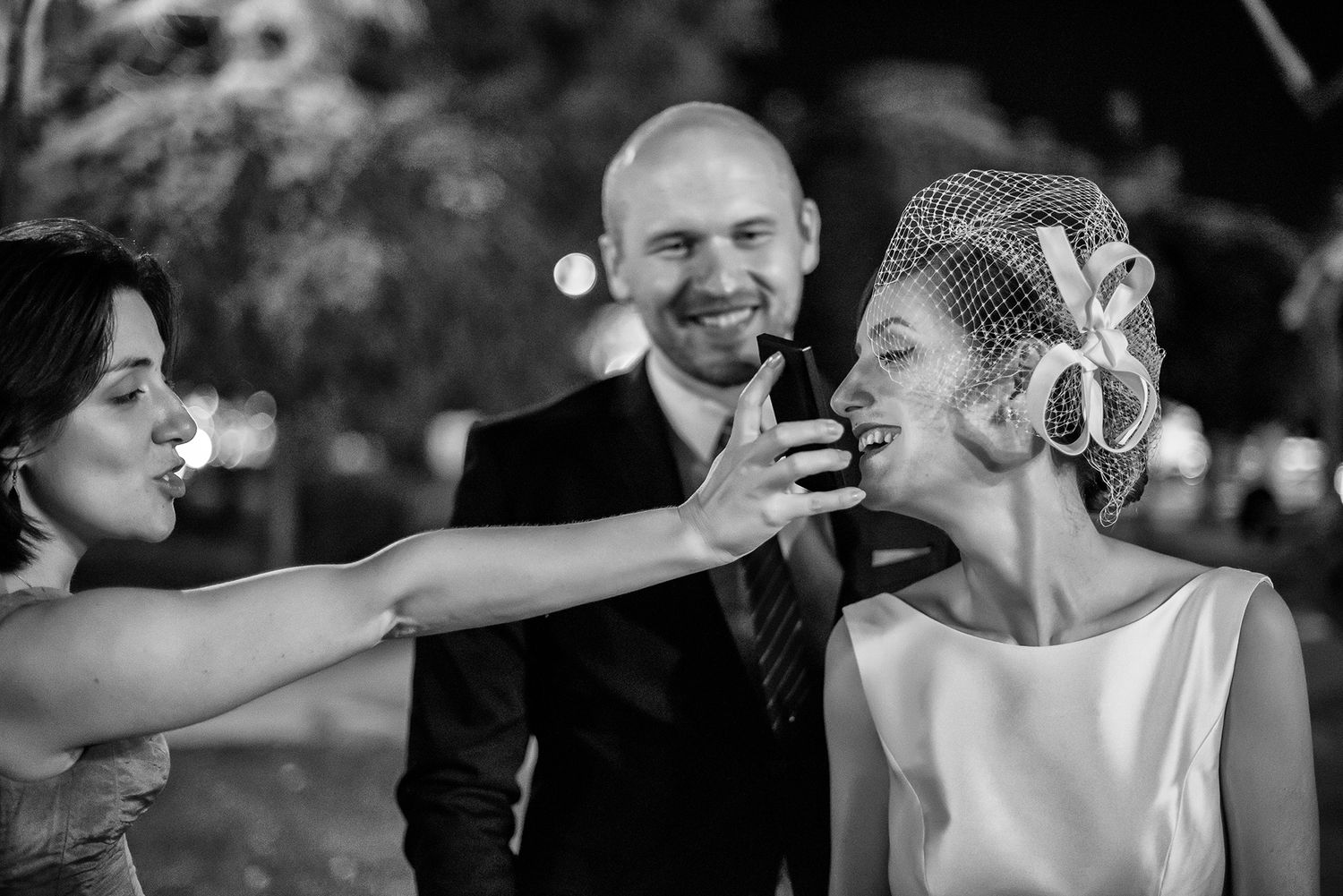 Black and white candid wedding reception photos showing guests dancing and celebrating.