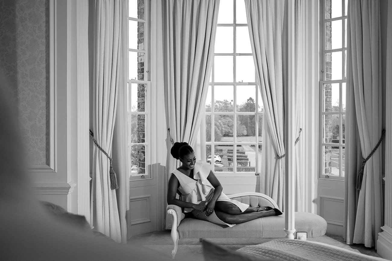 Bright interior room with tall windows and flowing curtains in natural light.