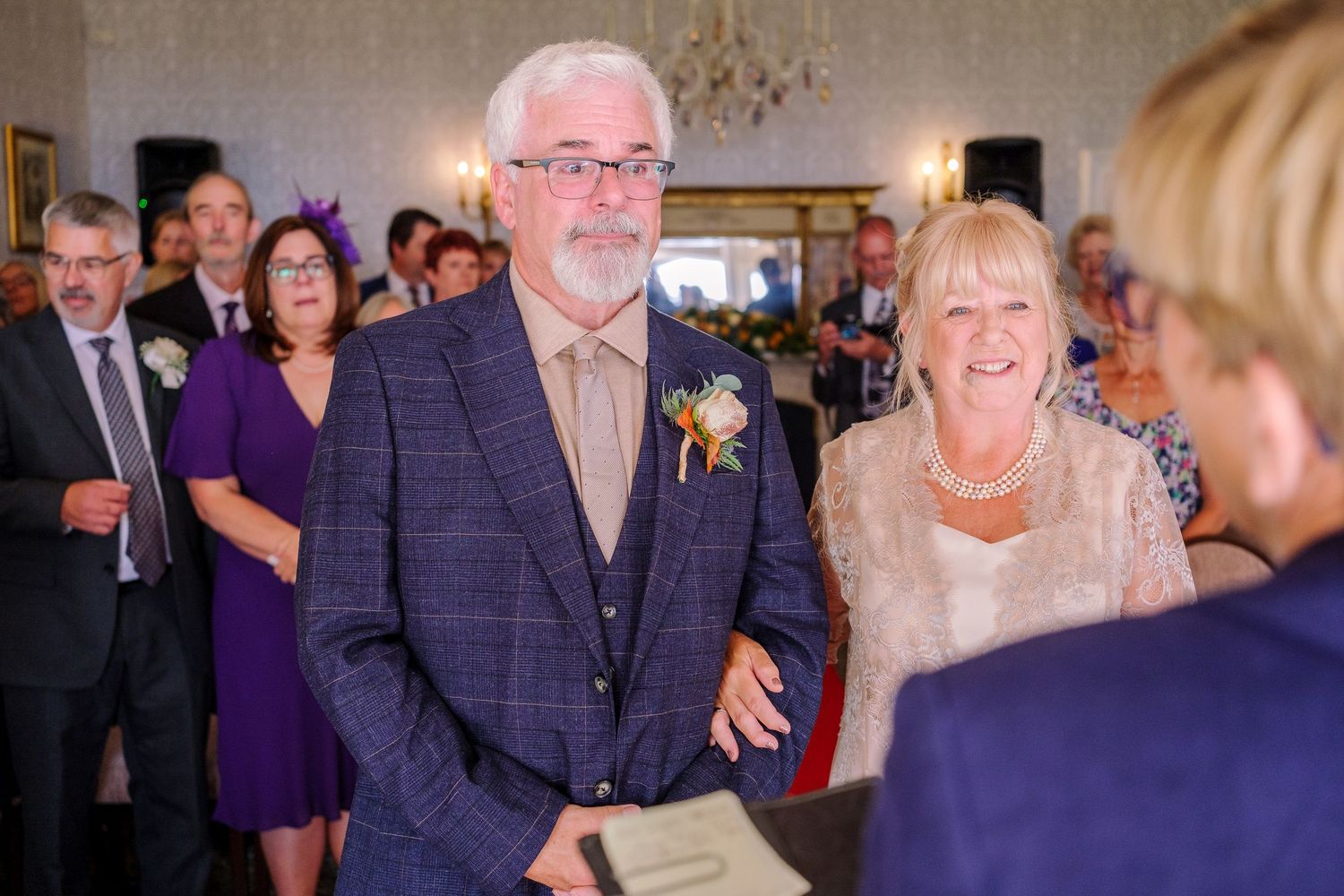Candid moments from a wedding celebration showing guests interacting in an ornate venue.