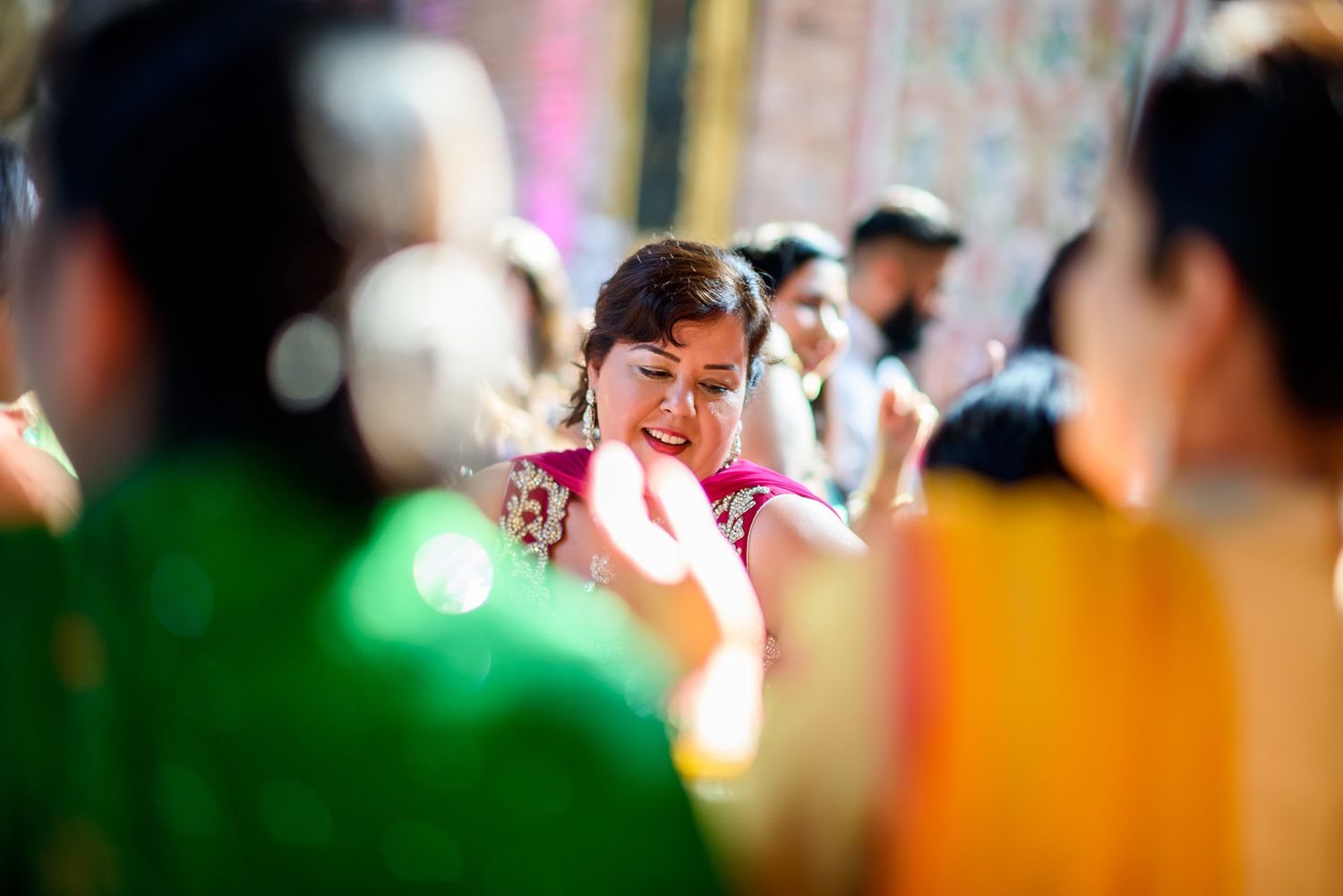 Colorfully decorated wedding reception venue with guests enjoying the celebration.