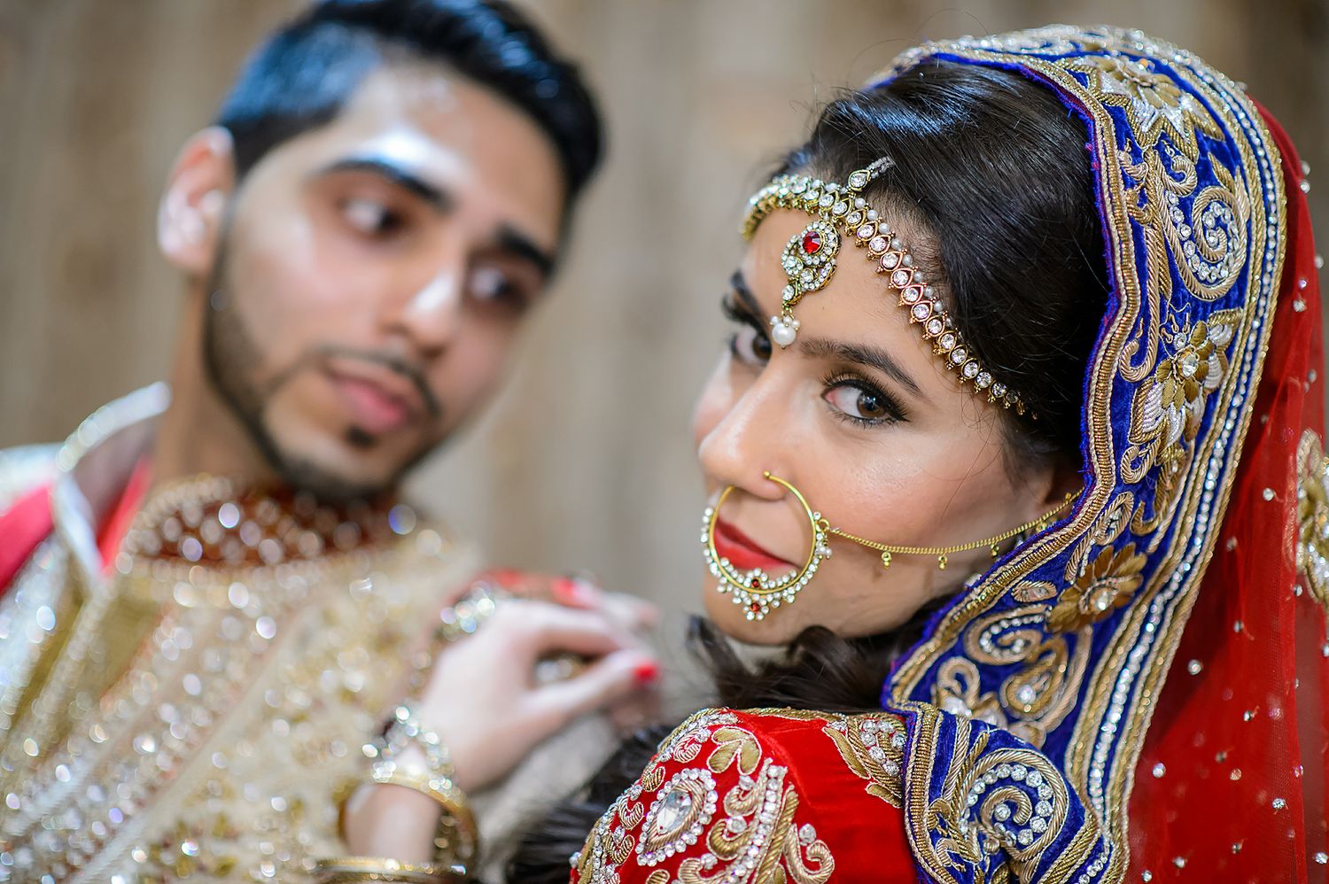 Close-up details of South Asian bridal jewelry and traditional wedding attire.
